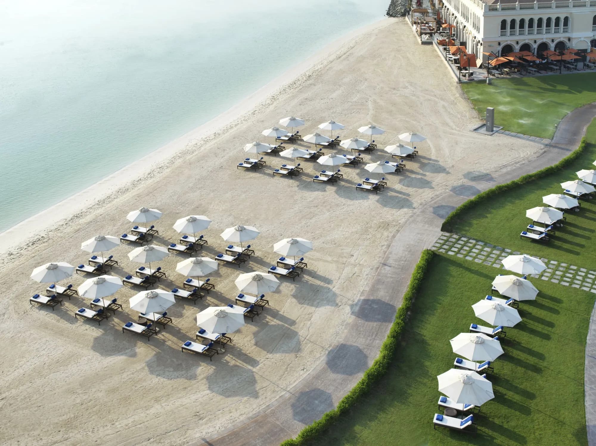 Aerial view of the private beach and Venetian-style resort buildings at The Ritz-Carlton Abu Dhabi Grand Canal