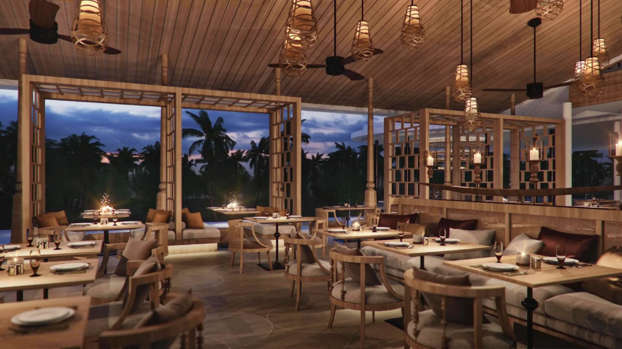 Covered al-fresco restaurant and dining pavilion at dusk at The Ritz-Carlton Koh Samui