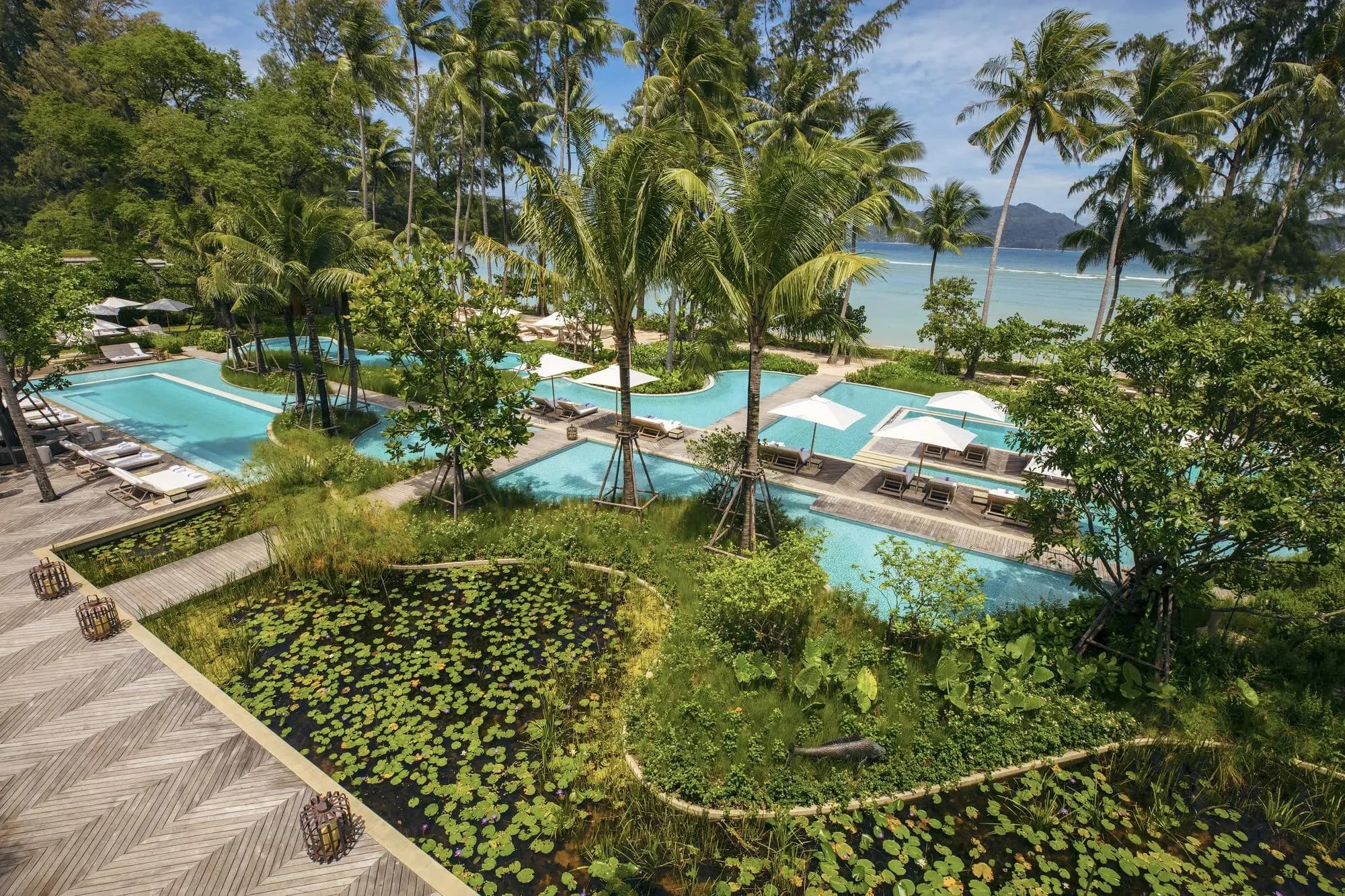Rosewood Phuket resort infinity pool merging with the Andaman Sea horizon at Emerald Bay, Phuket Thailand