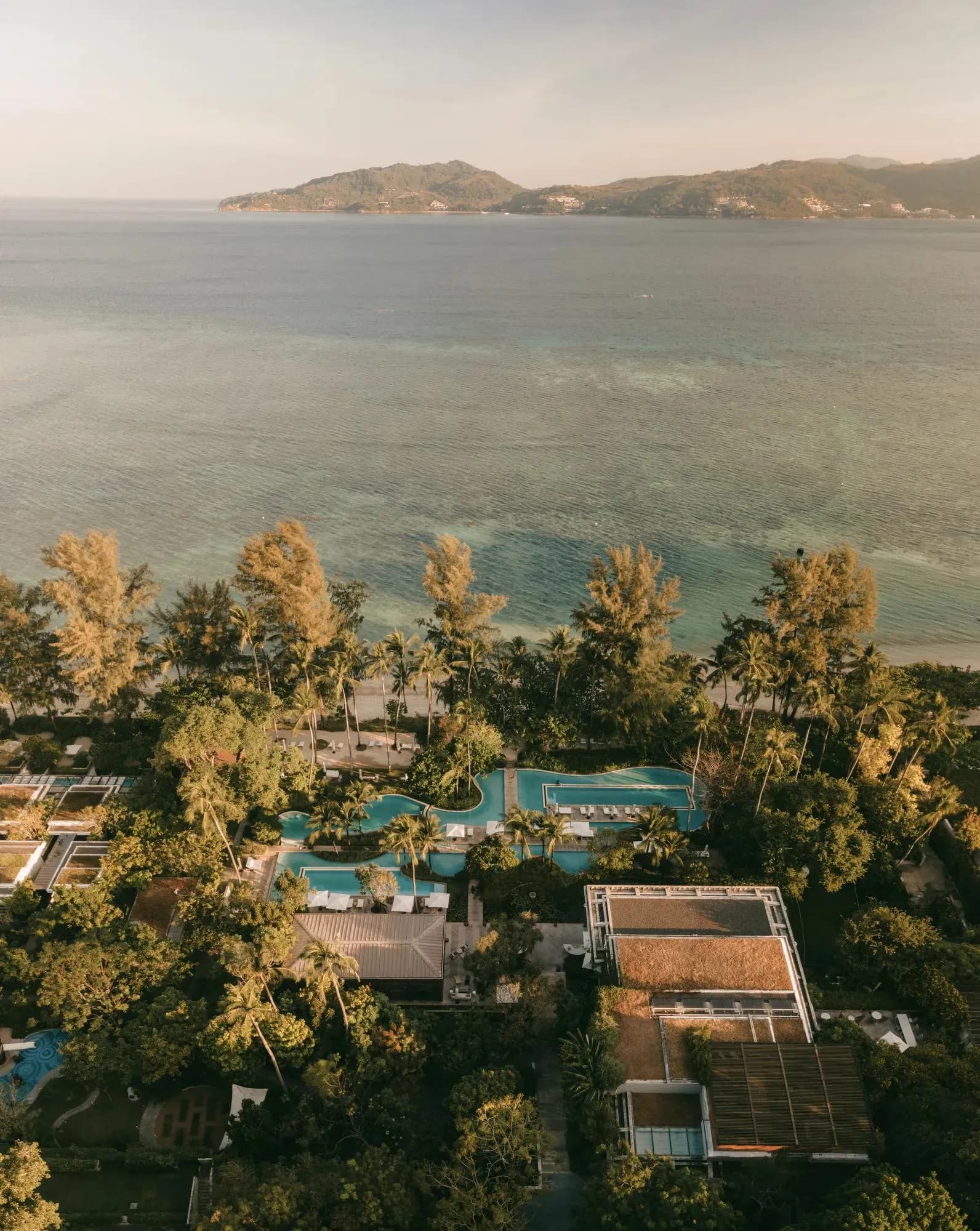 Aerial view of Rosewood Phuket resort along the private Emerald Bay beachfront, Andaman Sea, Phuket Thailand