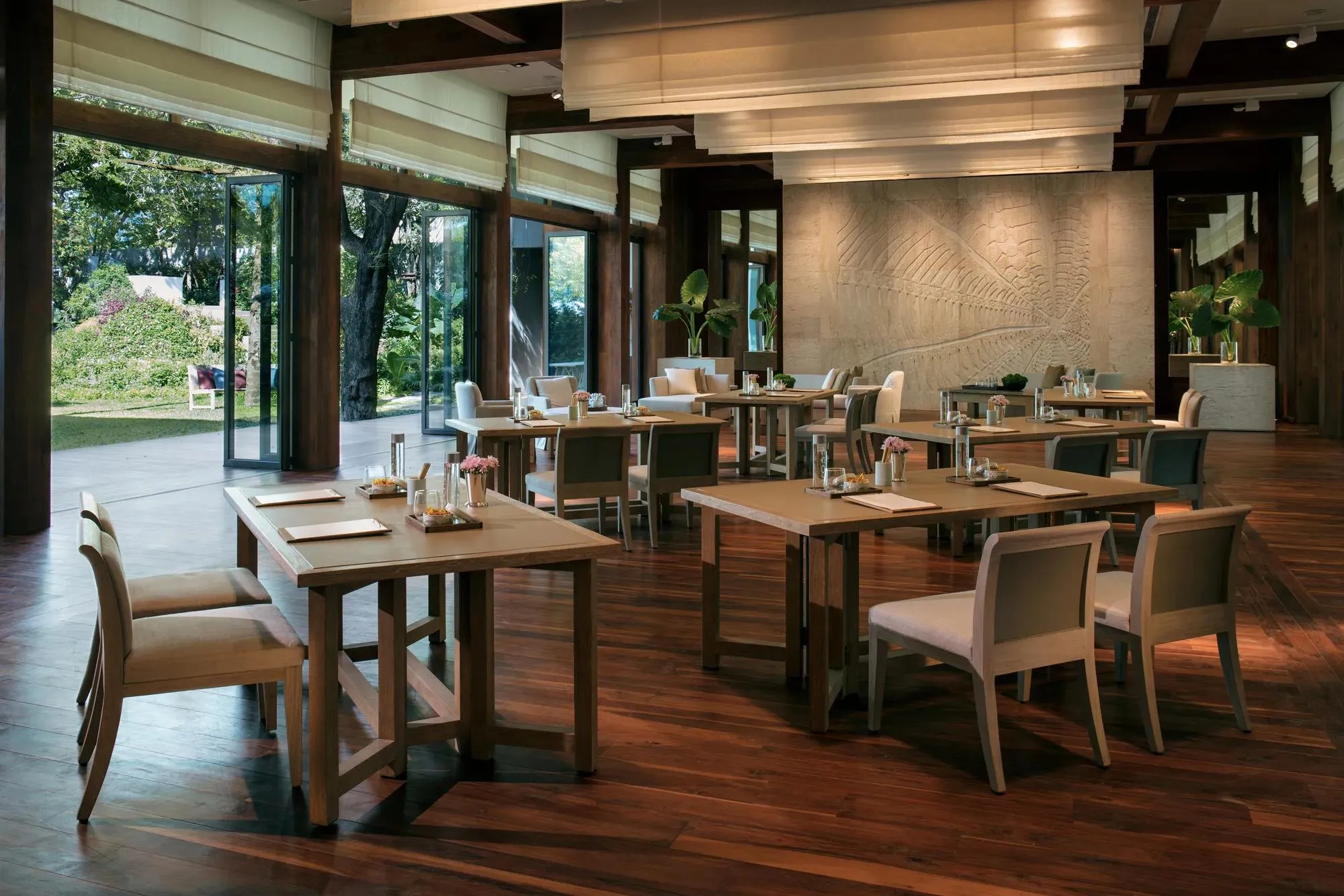 The Glass House indoor event pavilion with floor-to-ceiling windows over the Andaman Sea at Rosewood Phuket