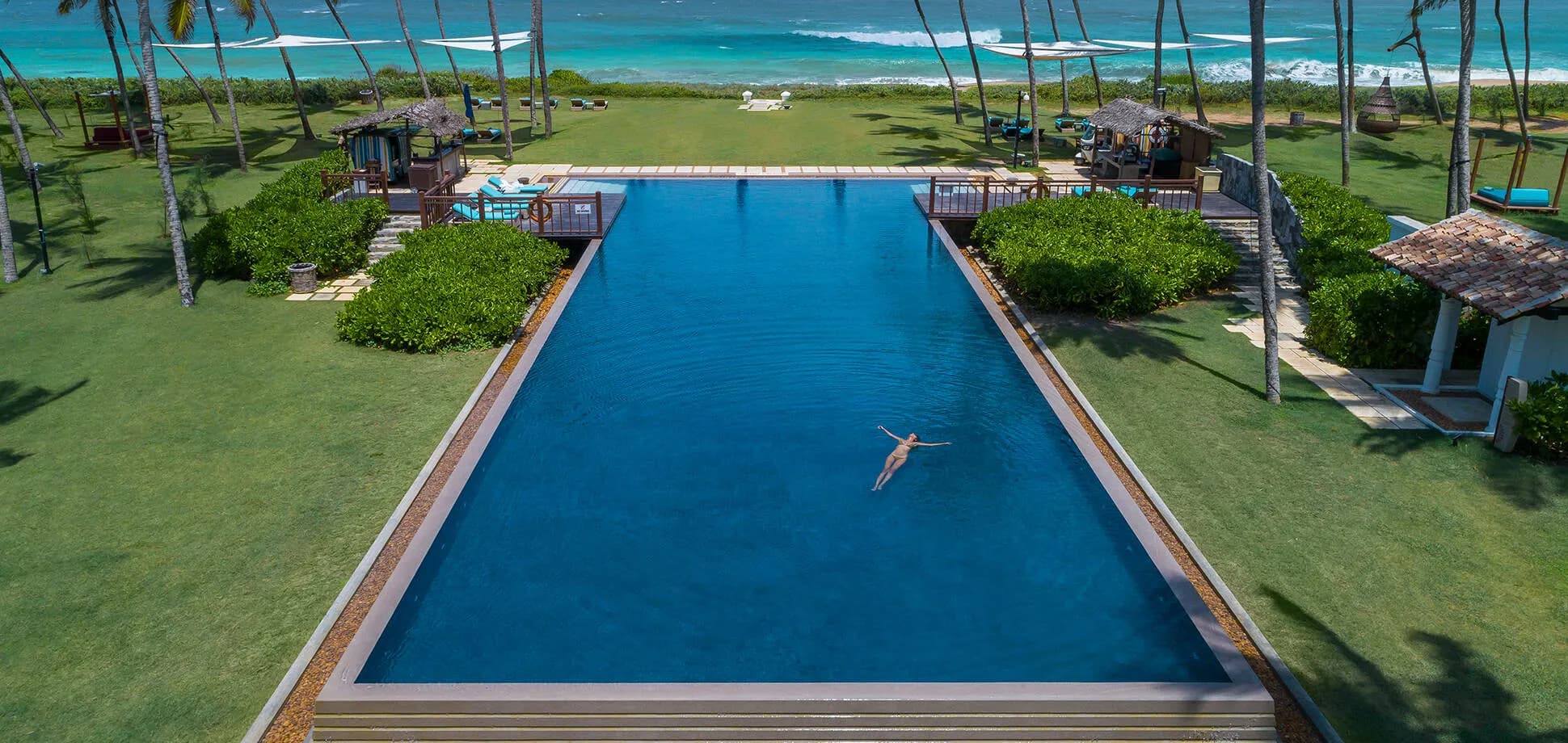 Swimming pool deck beside the Indian Ocean at Shangri-La Hambantota resort, Sri Lanka