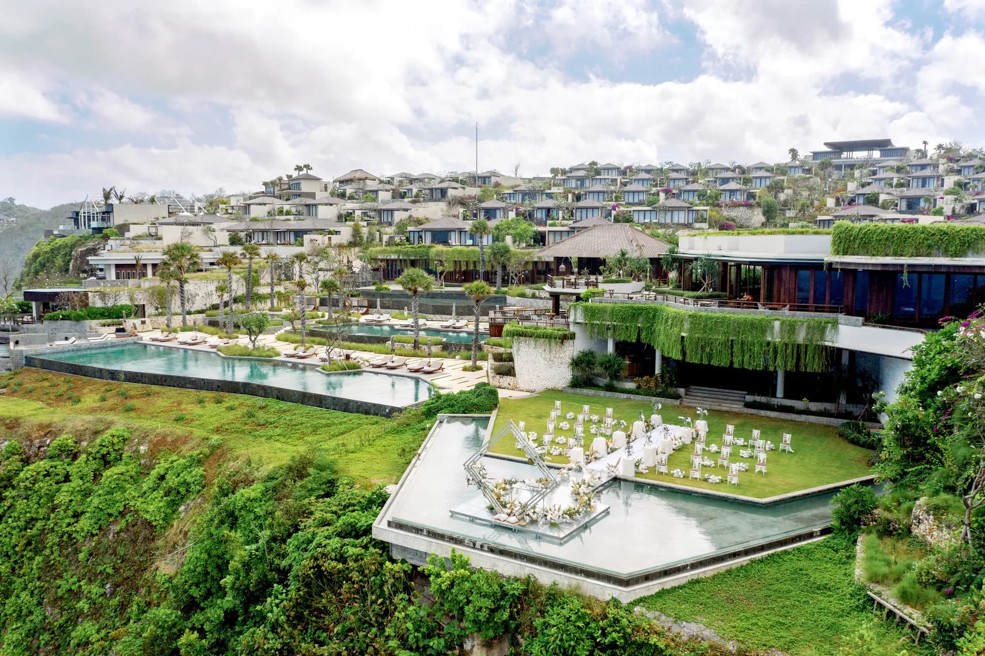 Aerial view of Six Senses Uluwatu Bali clifftop resort with the cliff-edge ballroom and ocean ceremony lawn above the Indian Ocean