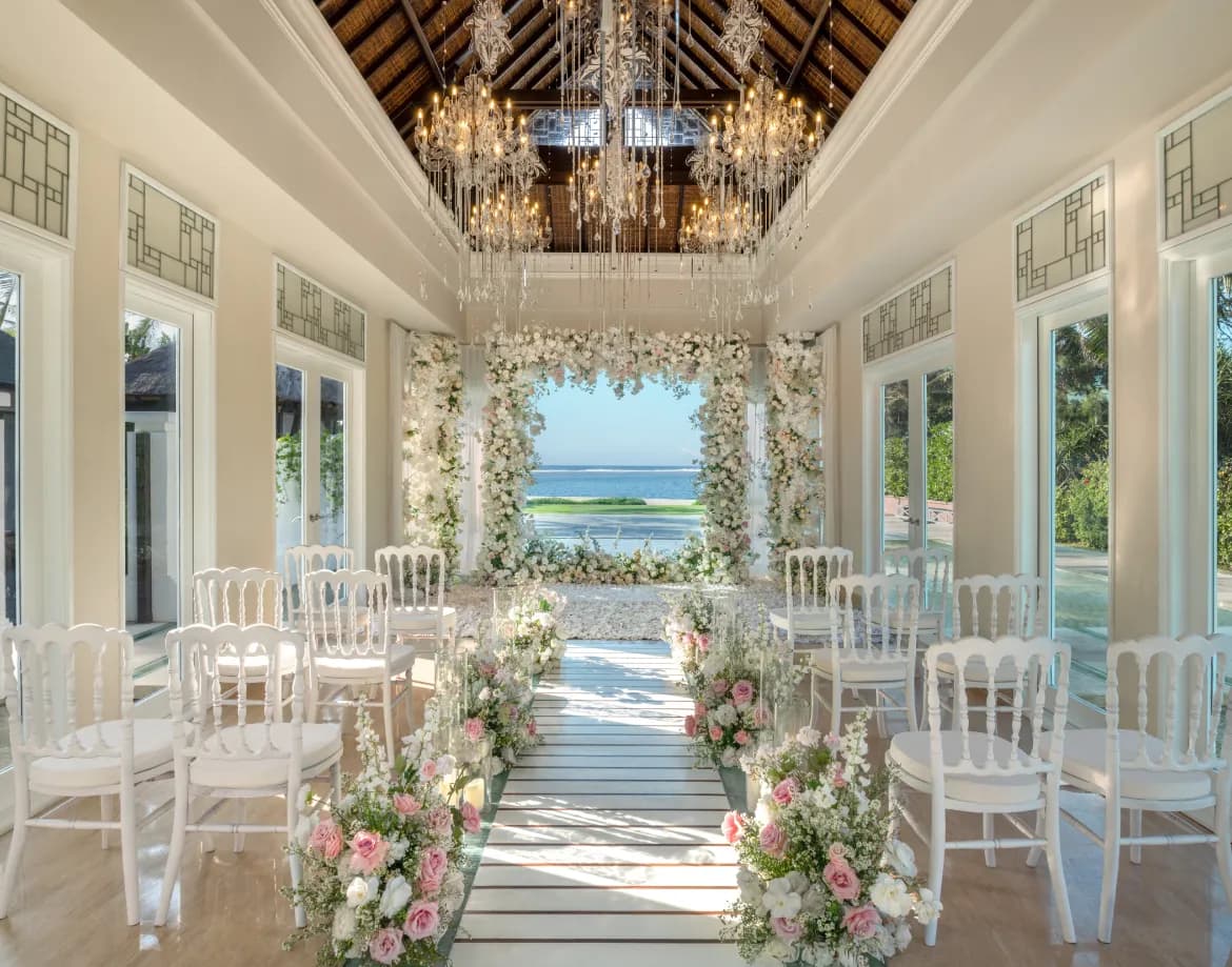 Interior of the glass Cloud Nine Chapel set with a floral arch and ocean view for a ceremony at The St. Regis Bali Resort, Bali
