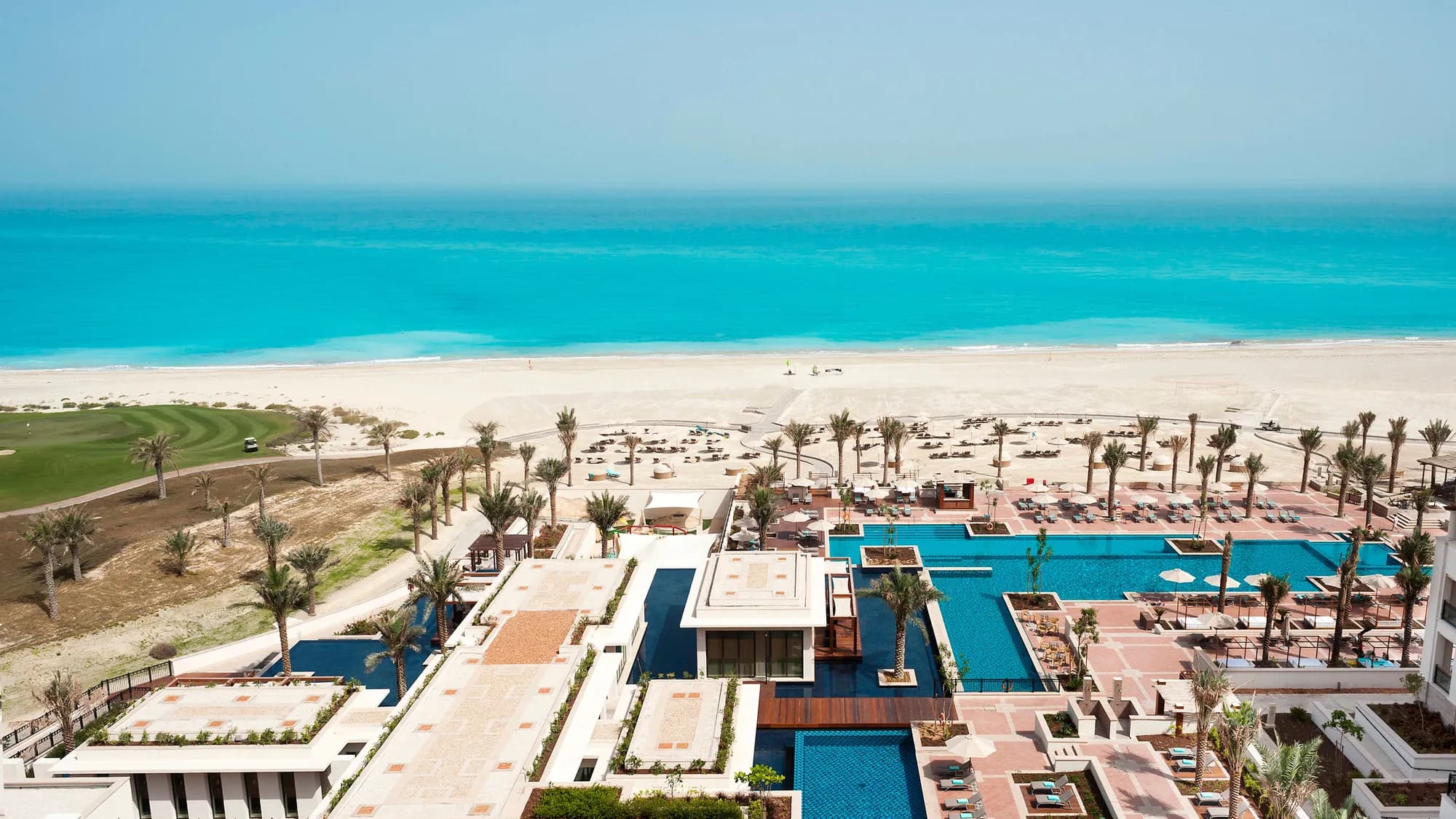 Aerial of The St. Regis Saadiyat Island Resort Abu Dhabi, a Mediterranean-style beach estate on a white-sand coastline beside the turquoise Arabian Gulf