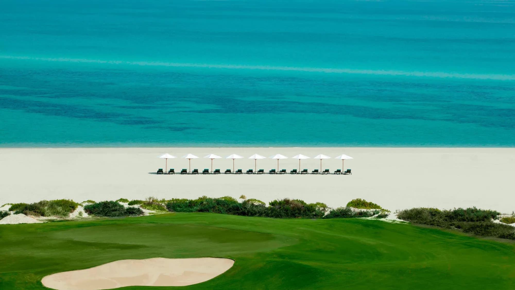 Beachfront ceremony and beach setting at golden hour at The St. Regis Saadiyat Island Resort, Abu Dhabi