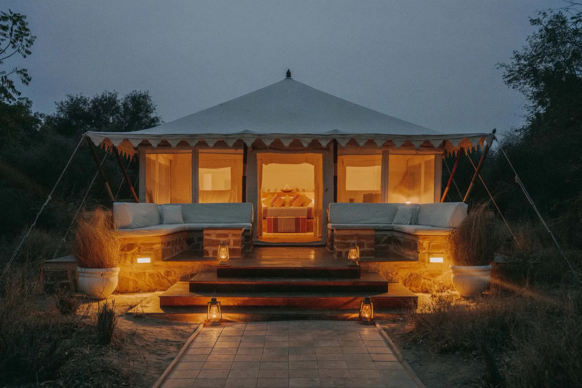 Row of 1920s-inspired luxury safari tents under dhok trees at SUJÁN Sher Bagh Ranthambore