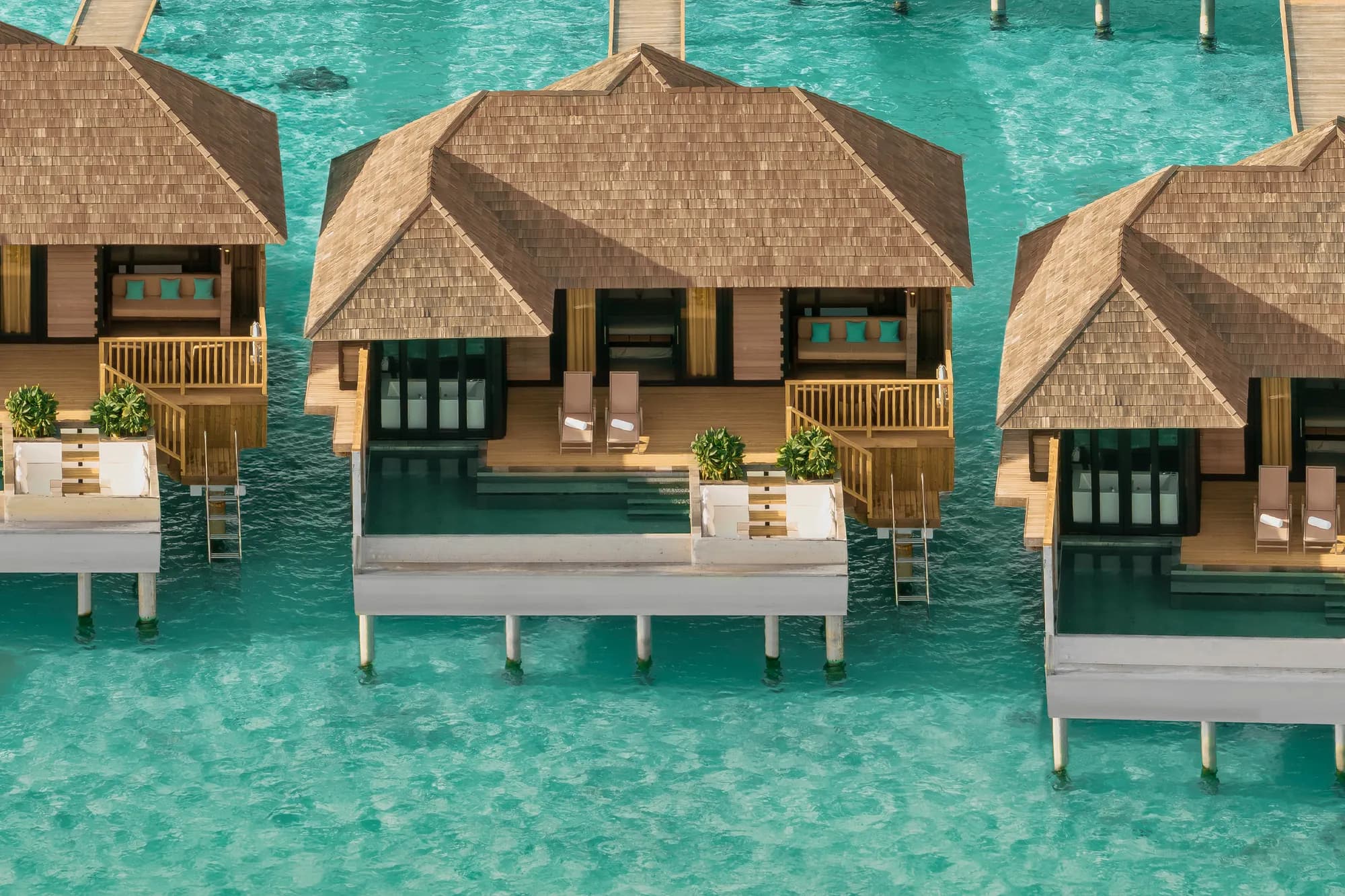 Aerial view of a horizon water villa with private pool over the lagoon at Sun Siyam Iru Fushi, Maldives