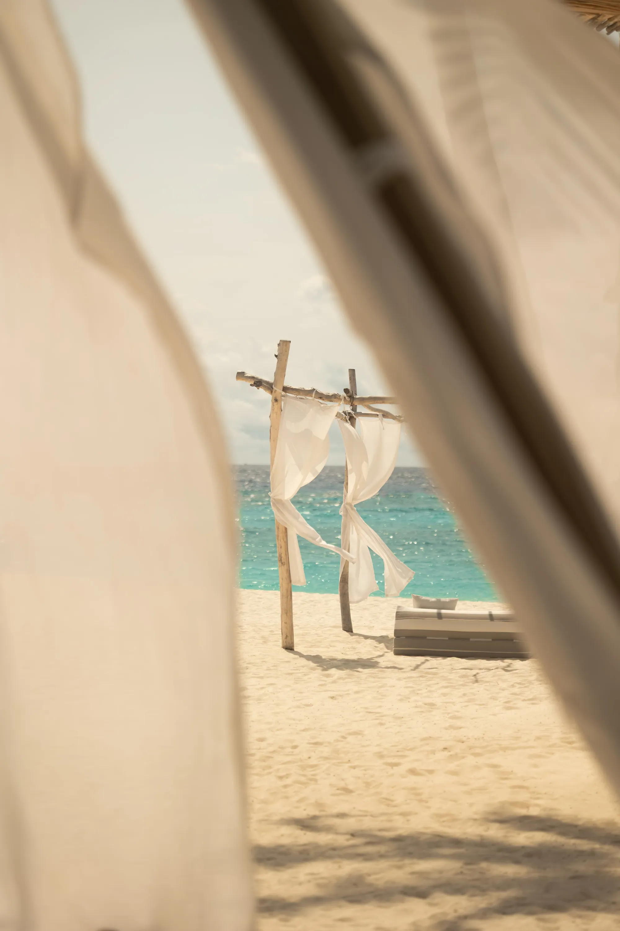 Tropical floral and arch wedding ceremony setup detail at Sun Siyam Iru Fushi, Maldives