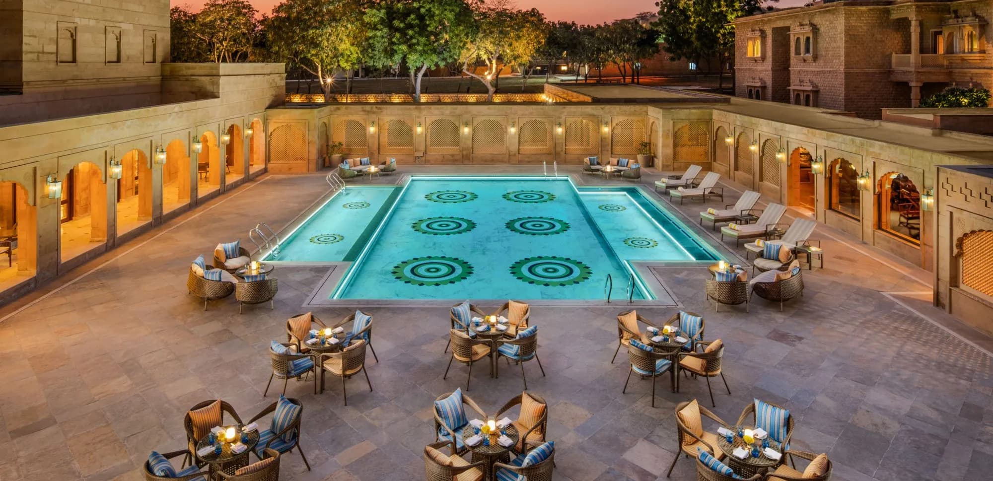 Swimming pool and poolside terrace surrounded by sandstone walls at Taj Gorbandh Palace, Jaisalmer