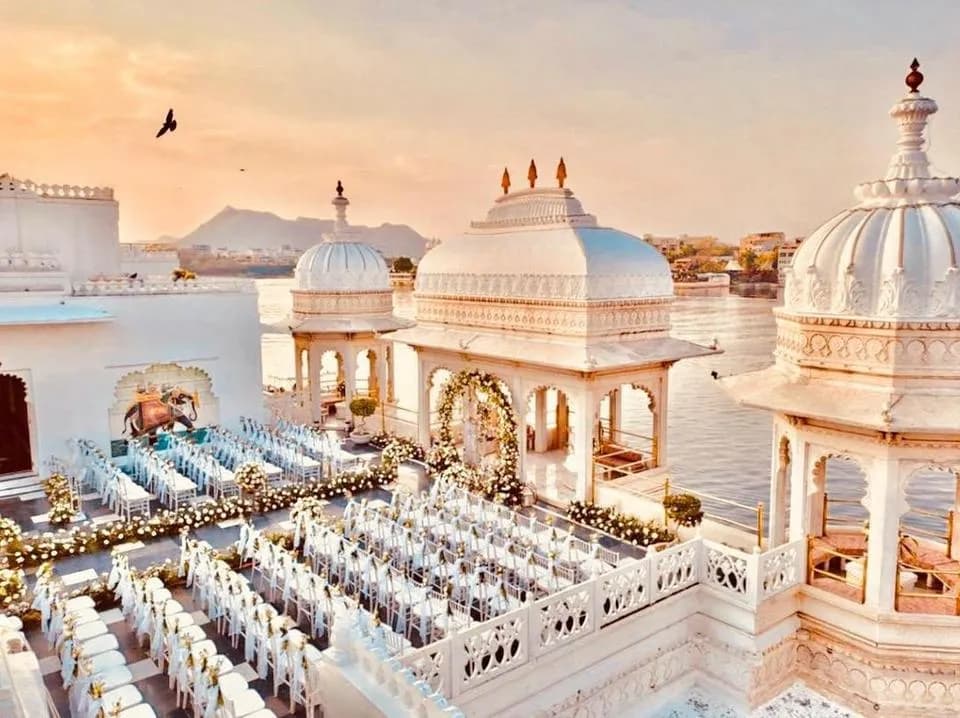 Rooftop reception setting at Taj Lake Palace with the Udaipur City Palace skyline