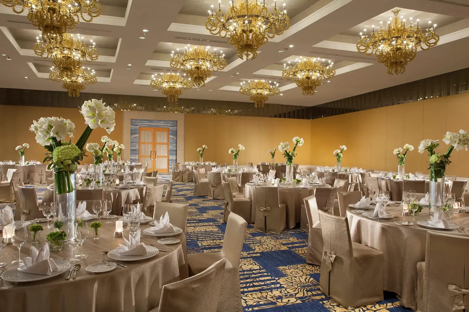 Violet Ballroom with crystal chandeliers set for a grand wedding reception at The Mulia Bali, Nusa Dua