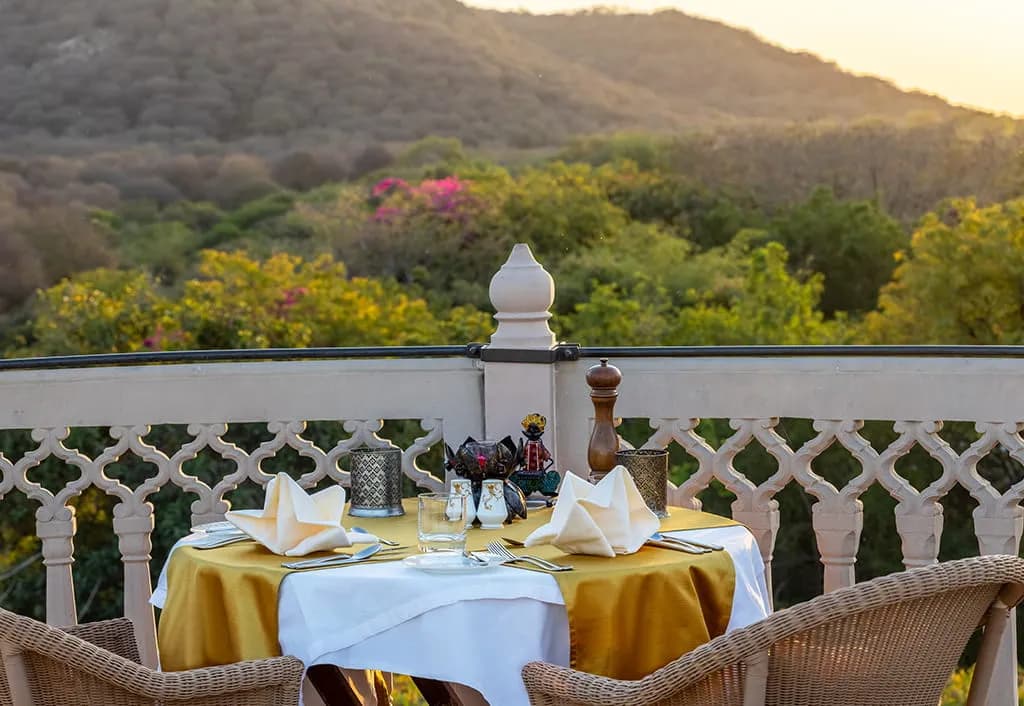 Personalised al-fresco dining setup by the lake and mango orchard at The Oberoi Vanyavilas Ranthambore
