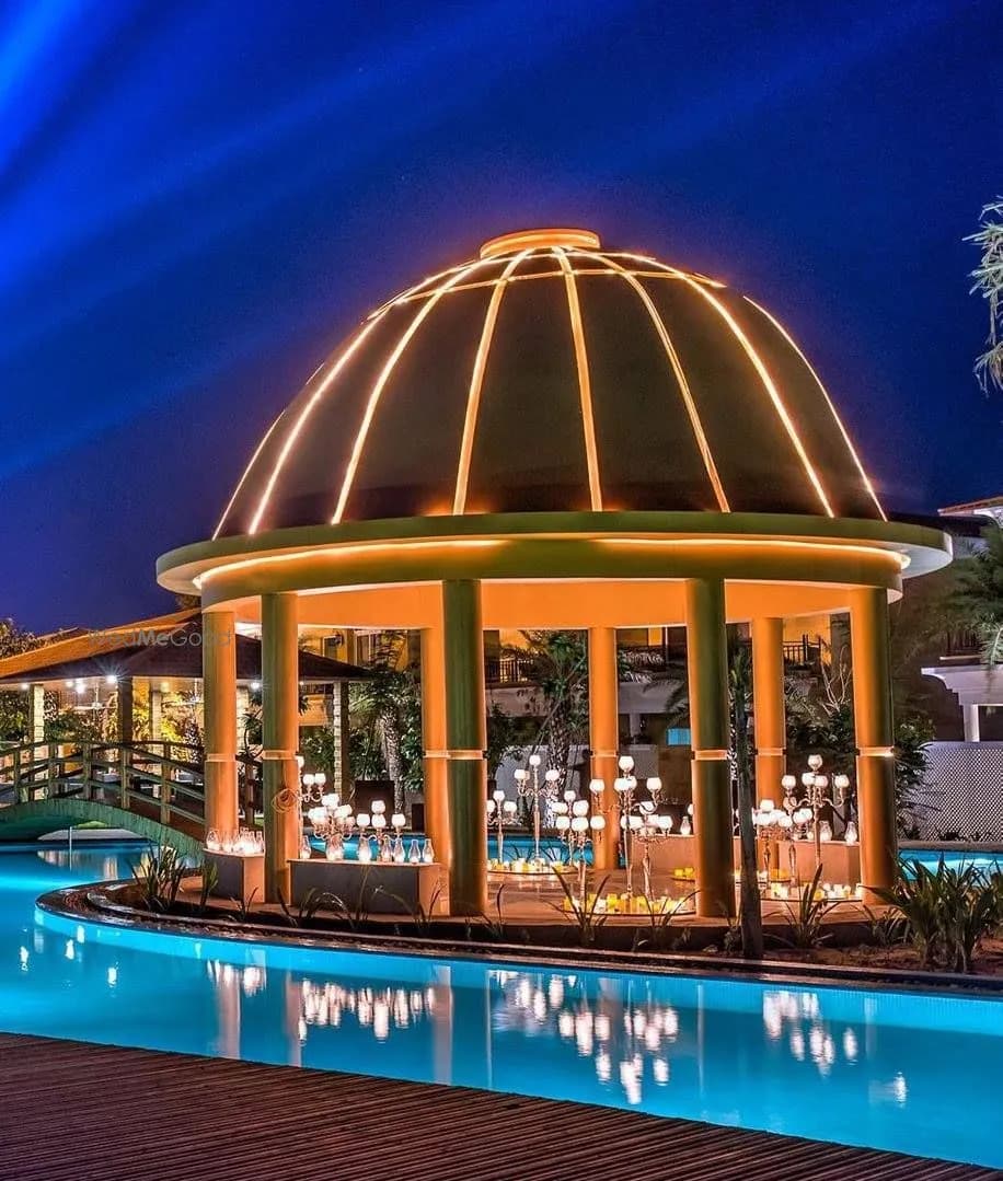 Illuminated domed pavilion candle-lit over the lagoon-style pool at night, The Westin Pushkar Resort & Spa