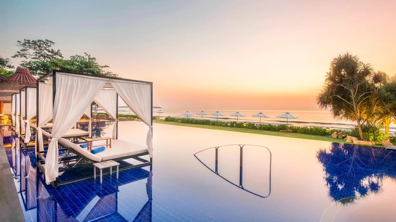 Poolside lawn and infinity pool overlooking the Gulf of Thailand at Vana Belle Koh Samui