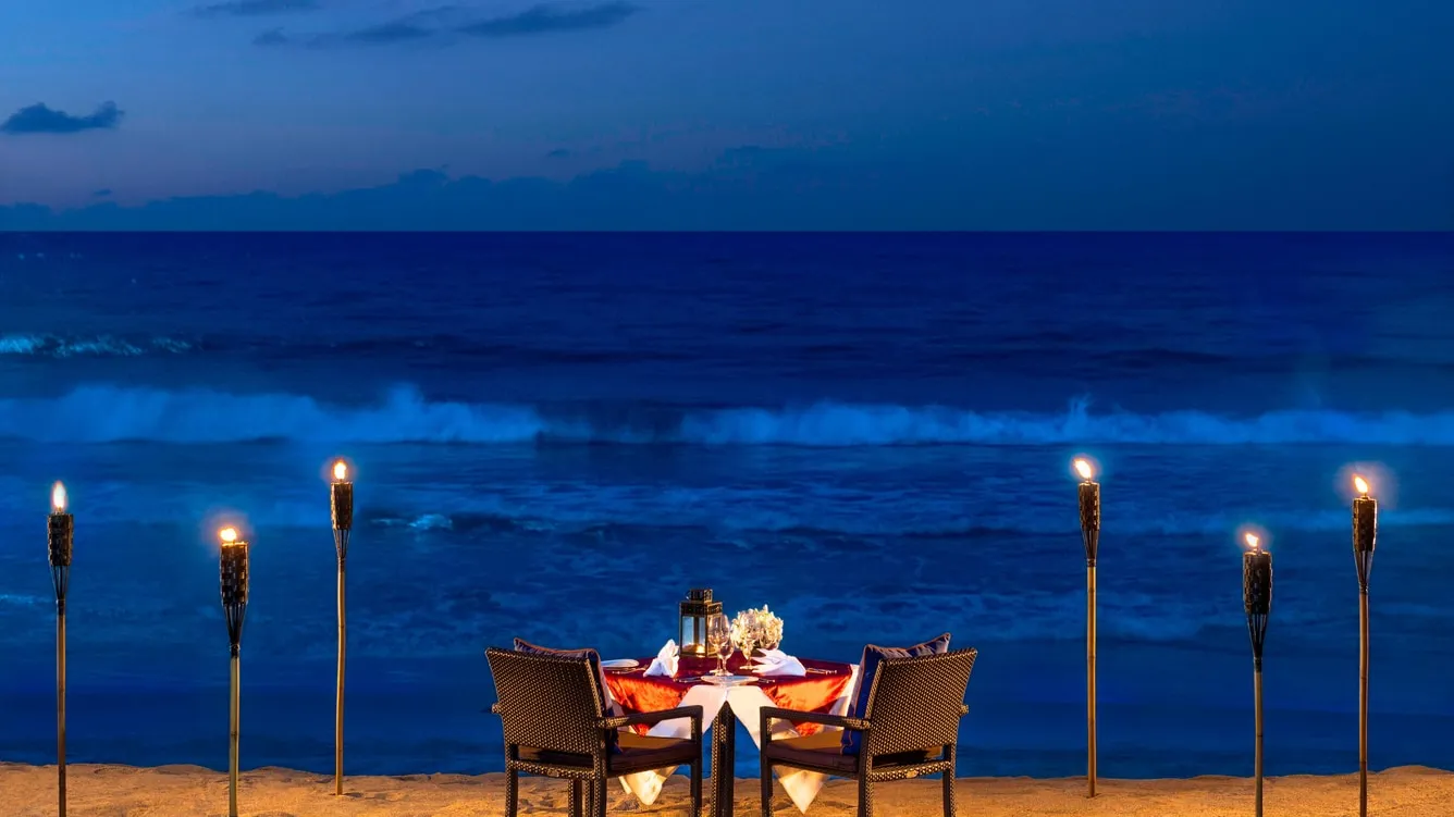 Beachfront dinner and celebration setup at dusk at Vana Belle Koh Samui