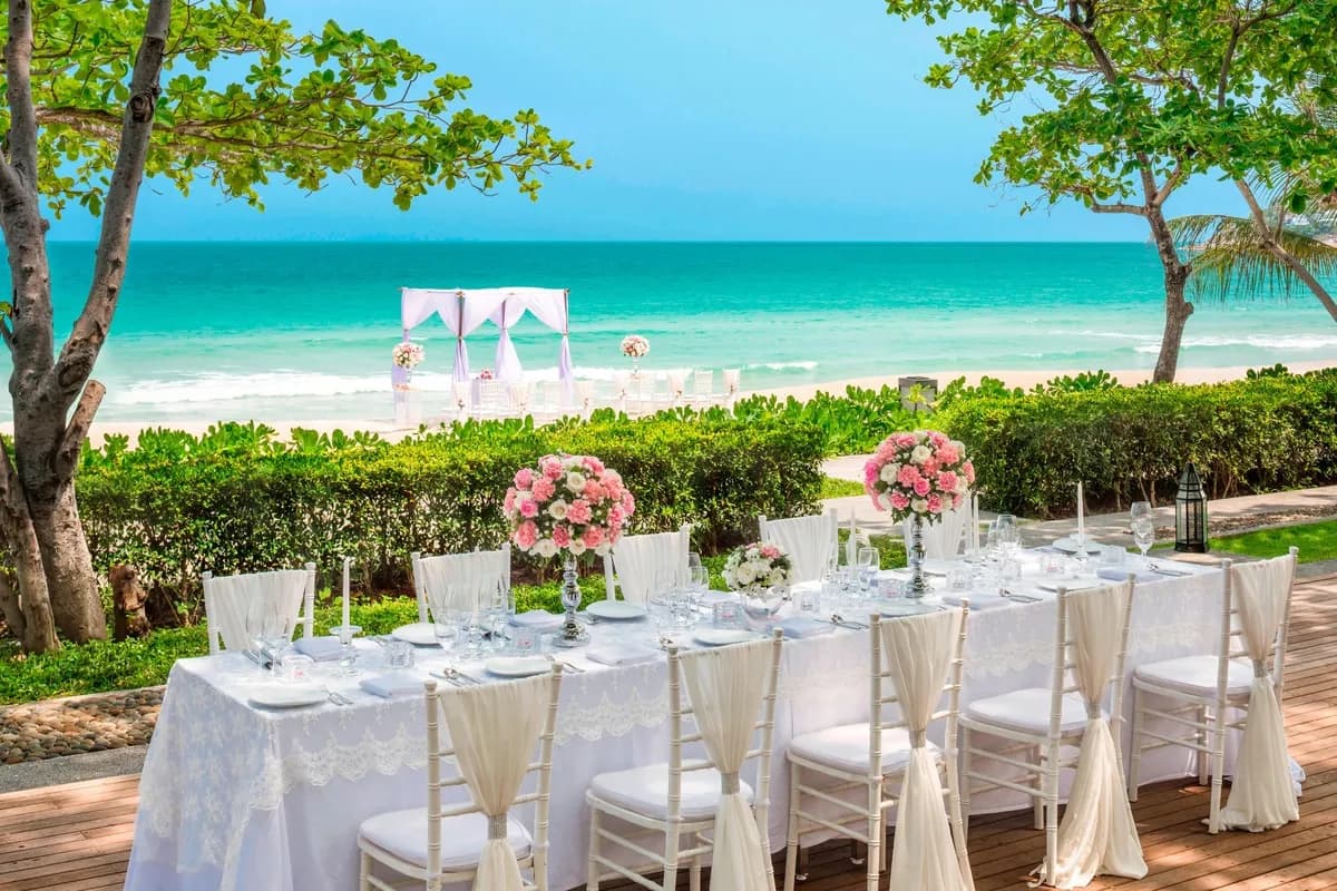 Wedding dinner reception table setup by the shore at Vana Belle Koh Samui