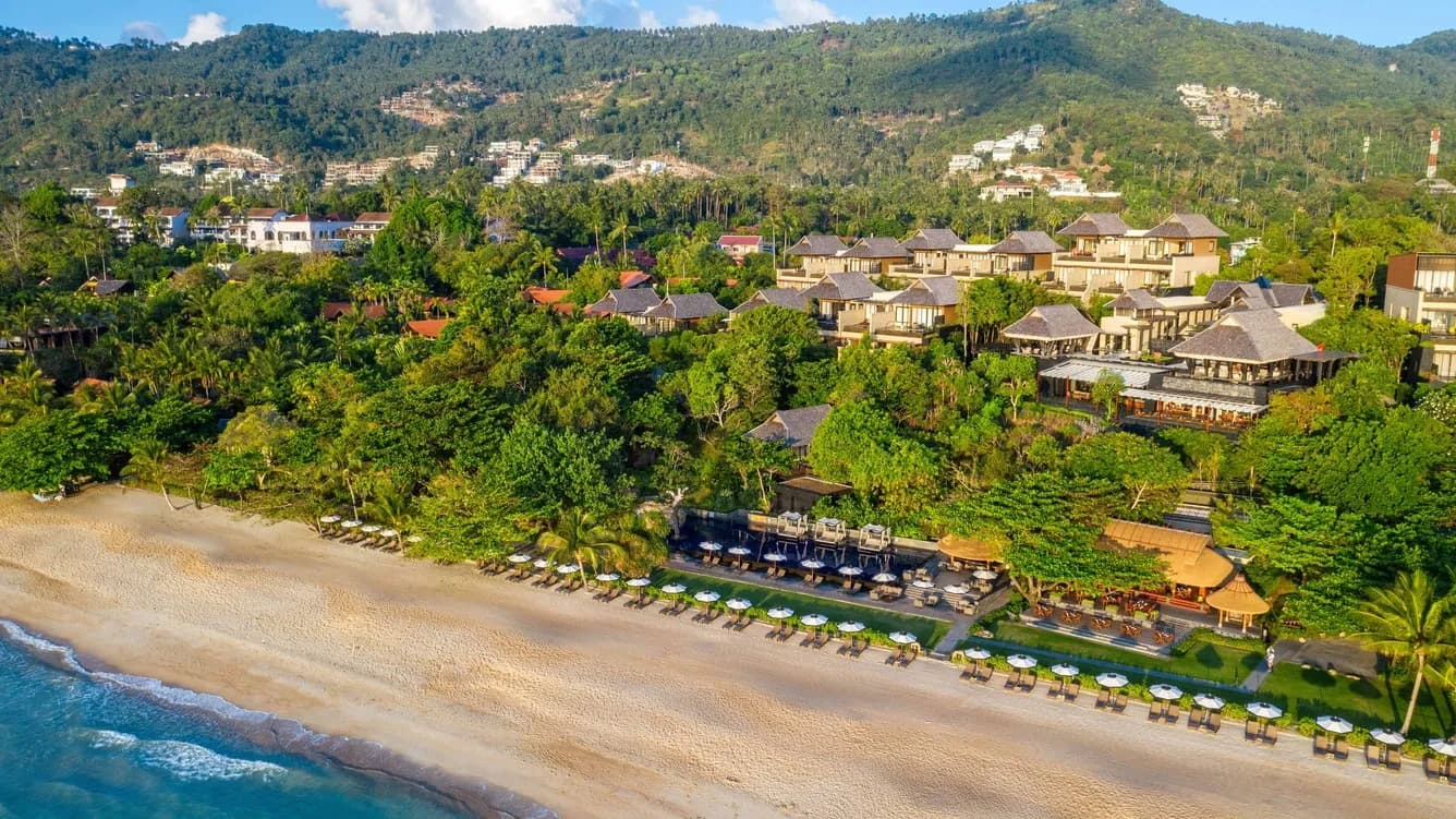 Aerial view of Vana Belle resort cove and Chaweng Noi Beach at golden hour, Koh Samui