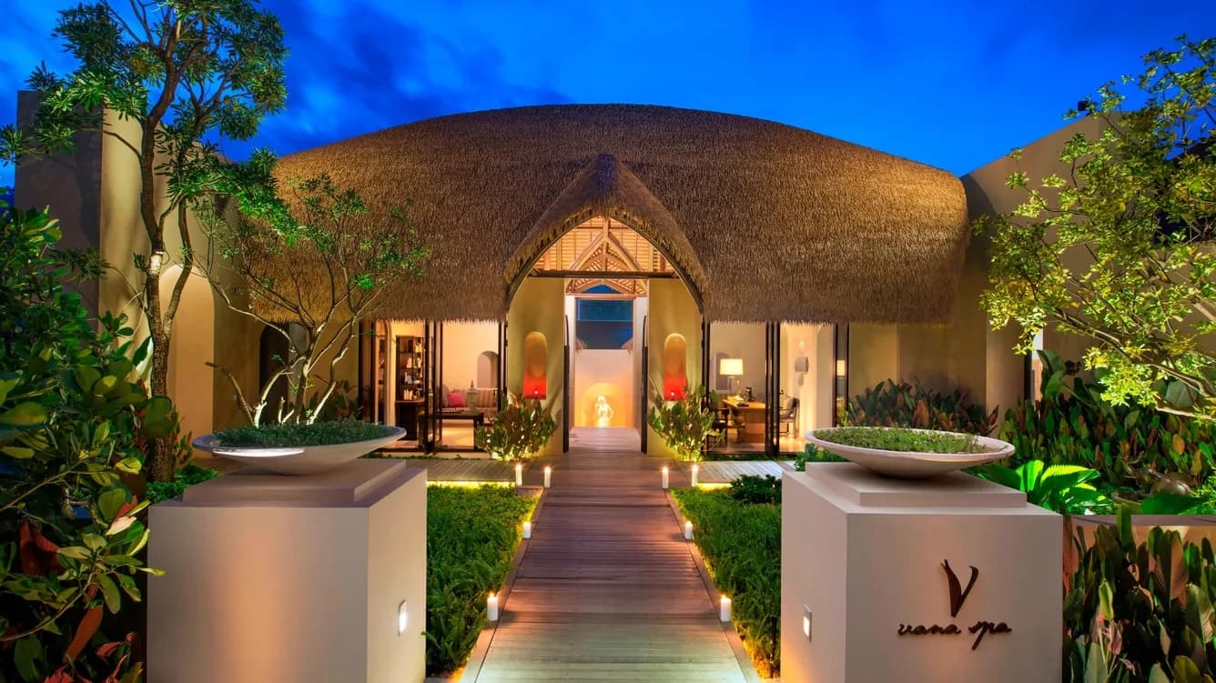 Vana Belle Luxury Collection resort hillside cove and Chaweng Noi Beach glowing at dusk, Koh Samui