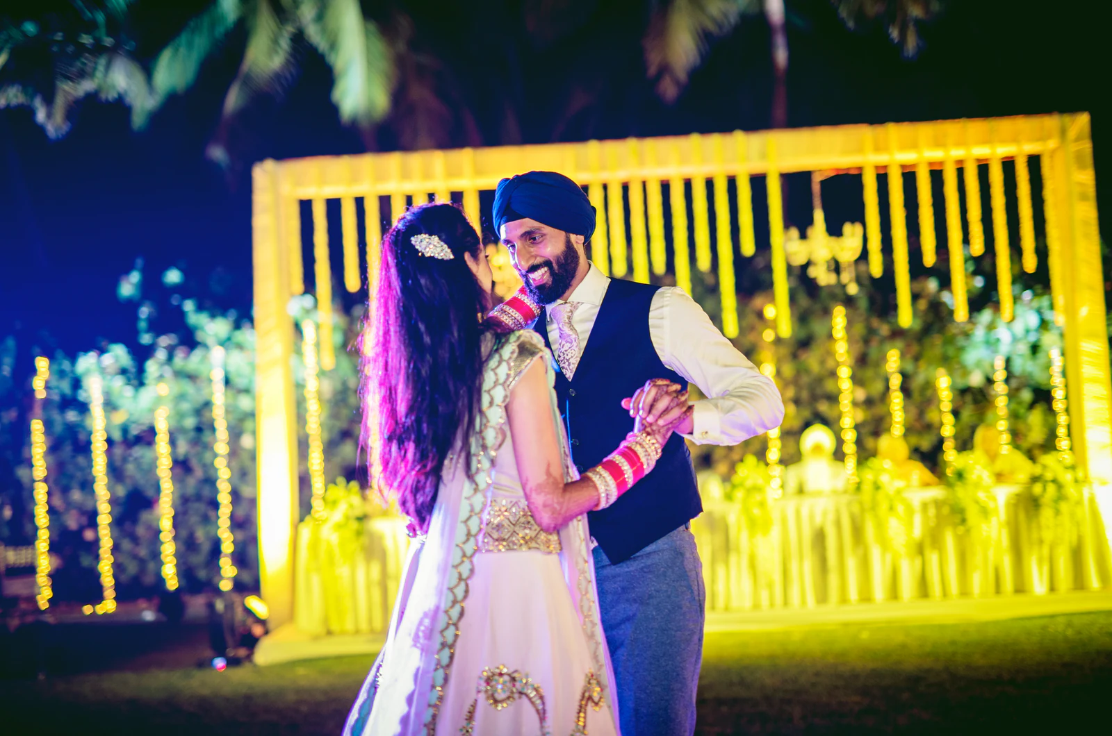 Couple dancing at a sangeet celebration
