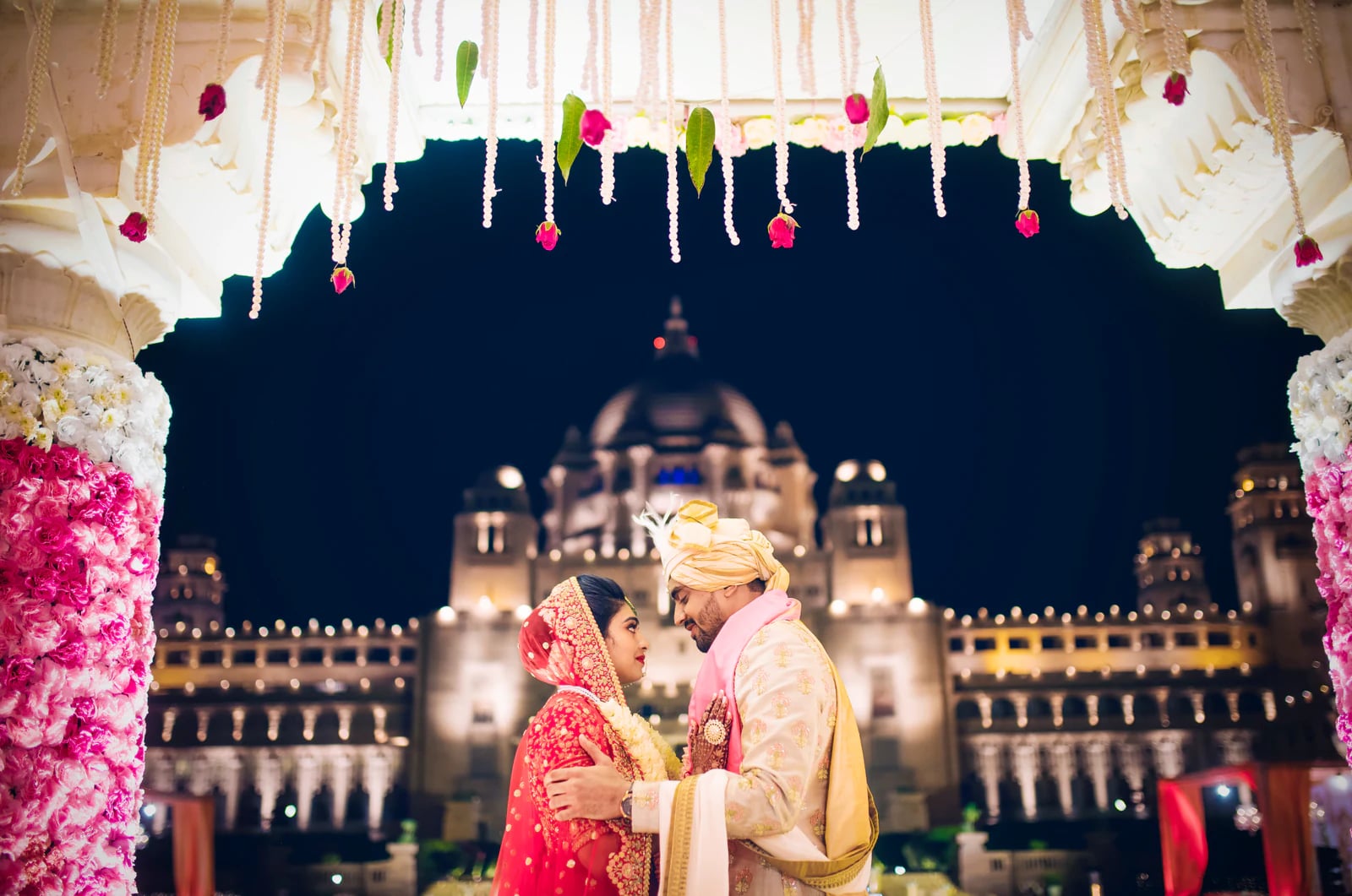 Couple at their palace wedding vows at night