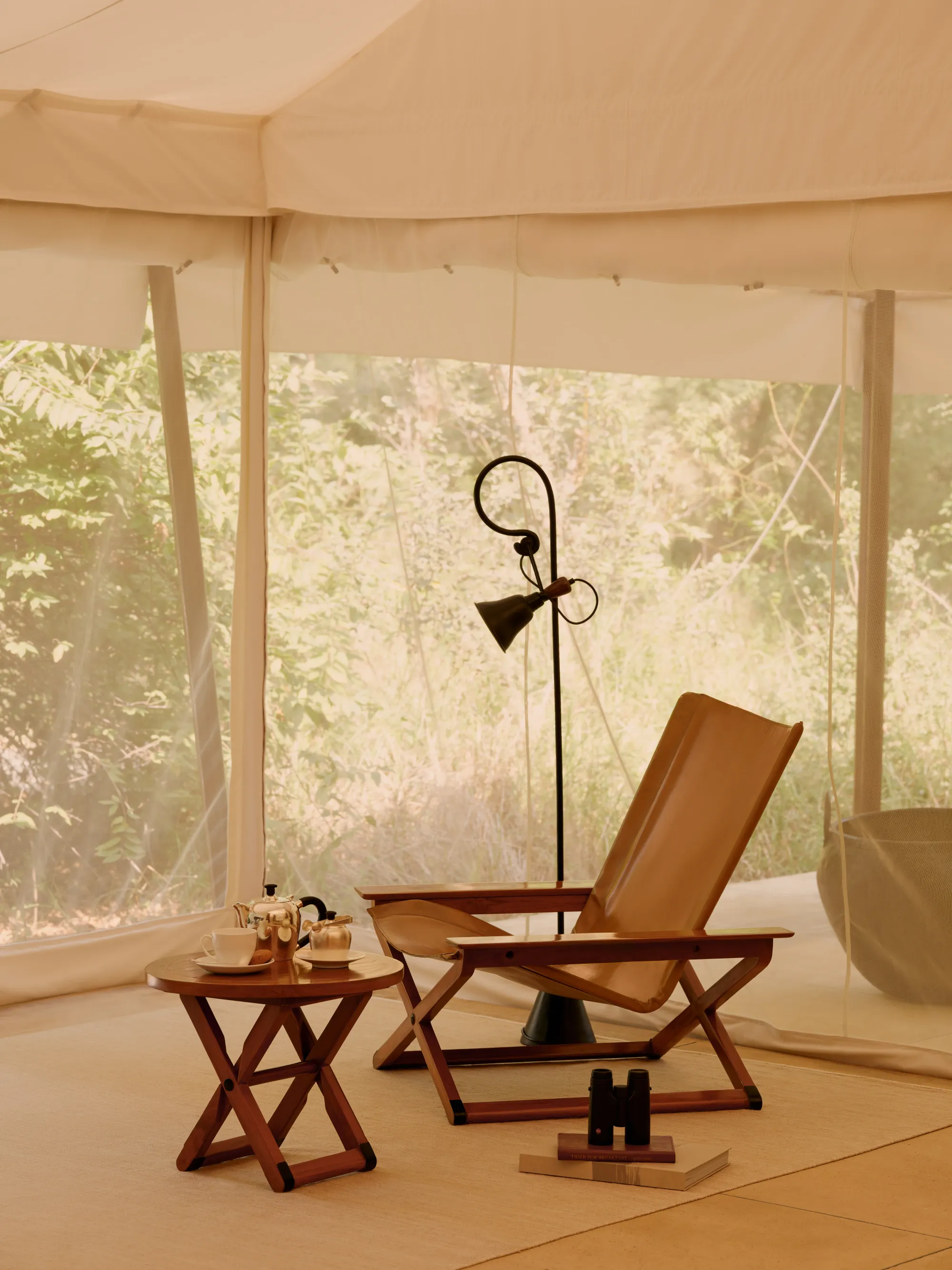 Aman-i-Khas Ranthambore cream Mughal-style canvas tented pavilion exterior lit at dusk among trees