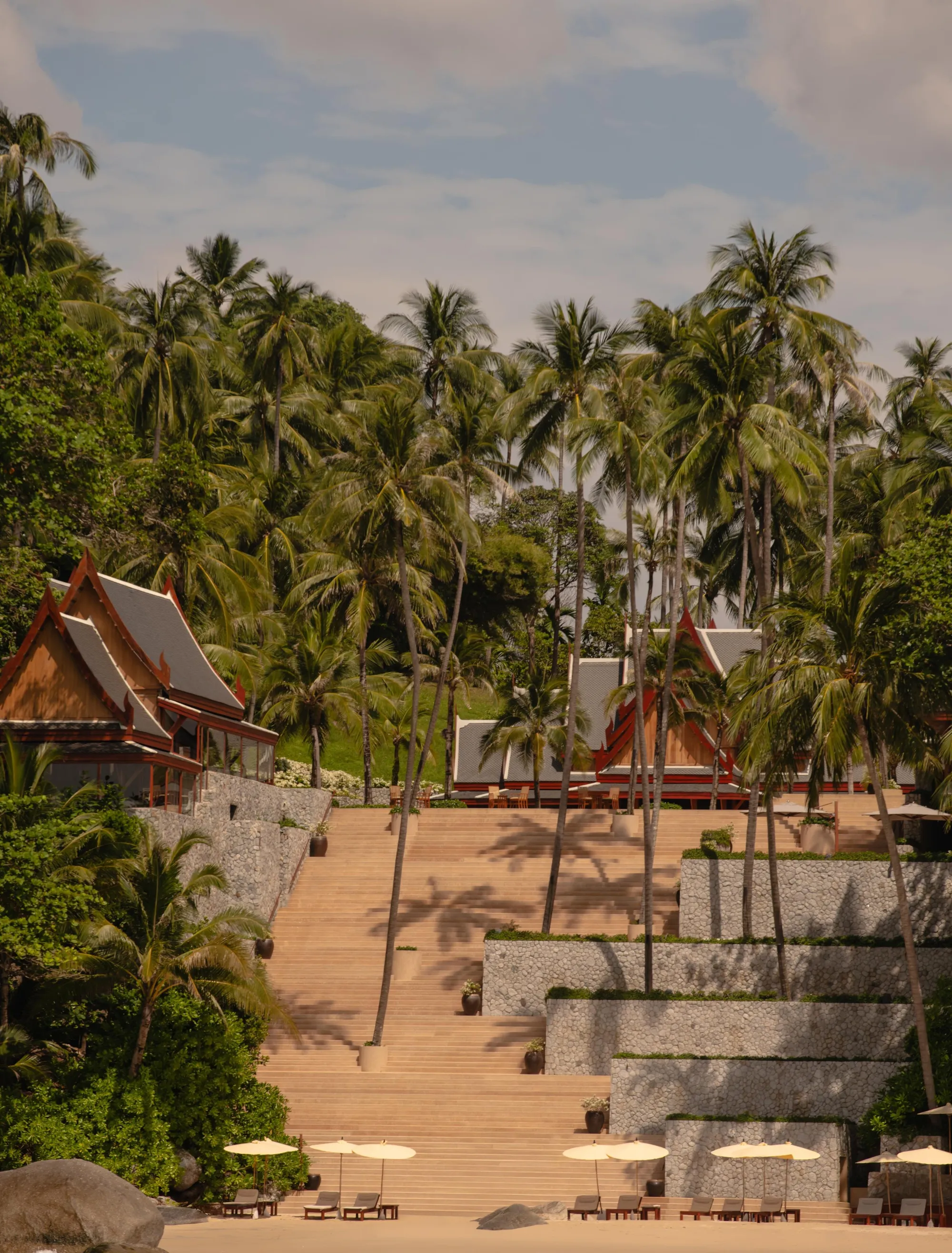 Stone steps leading from the Amanpuri headland down to white-sand Pansea Beach, Phuket
