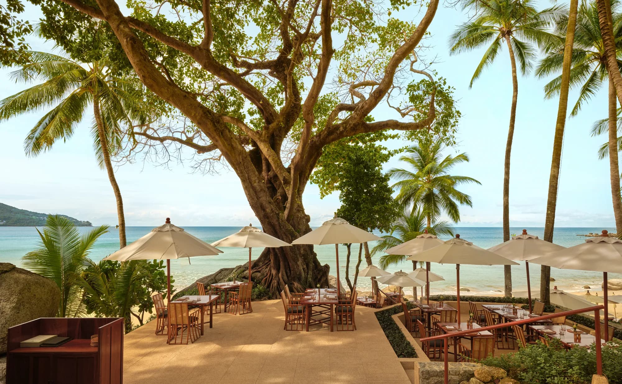 Beach Terrace upper-deck dining table set up above the Andaman Sea at Amanpuri, Phuket