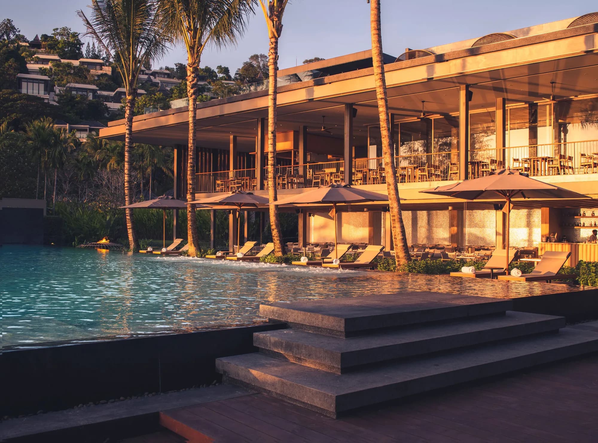 Anantara Layan Phuket Resort beachfront Beach House and main pool on Layan Beach cove facing the Andaman Sea at golden hour