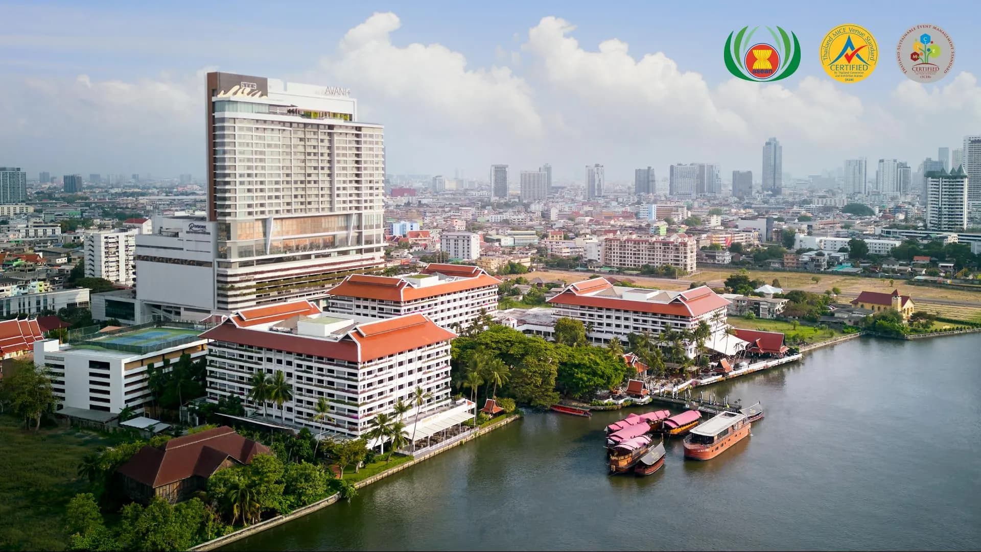 Aerial view of AVANI+ Riverside Bangkok tower and the riverside complex on the Chao Phraya River