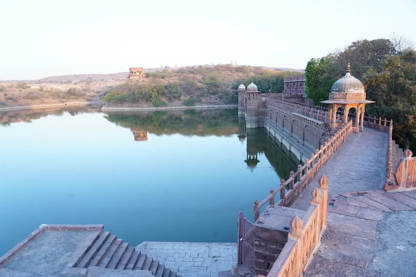 WelcomHeritage Bal Samand Lake Palace red-sandstone heritage palace overlooking the lake near Jodhpur at golden hour