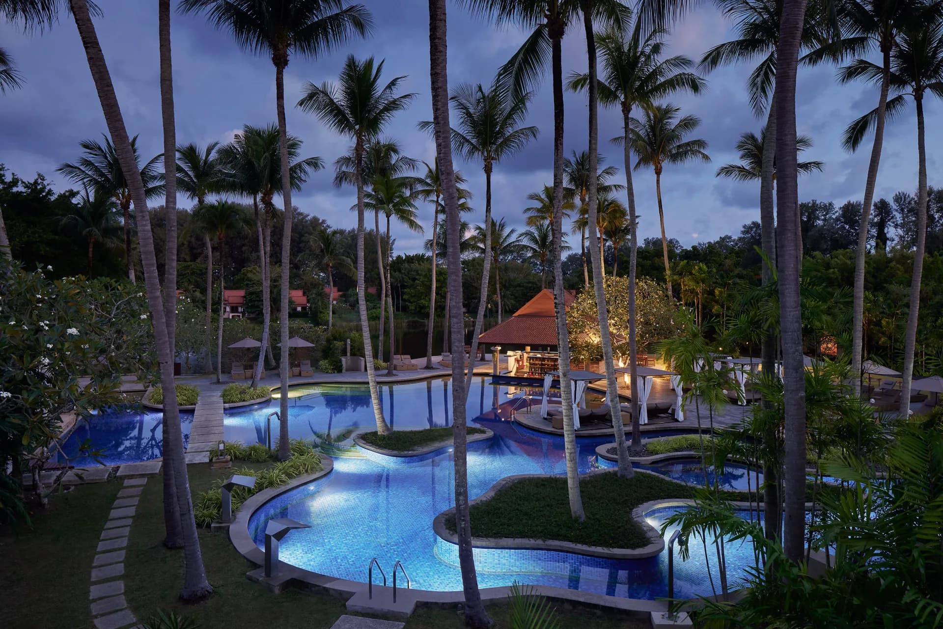 Banyan Tree Phuket lagoon and pool villas glowing at golden hour on Bang Tao Bay, Thailand