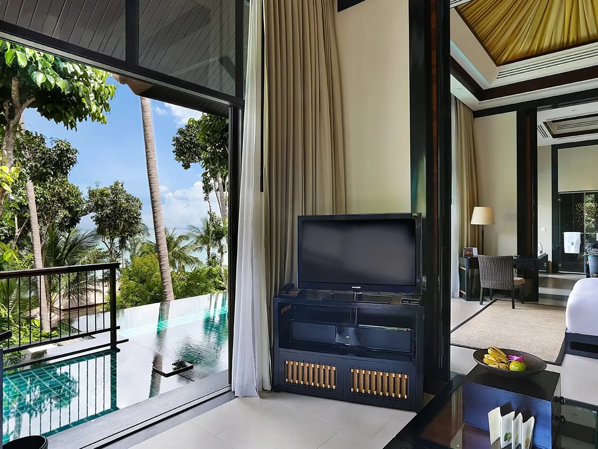 Banyan Tree Samui pool villa interior opening to a private infinity pool and ocean view through the palms