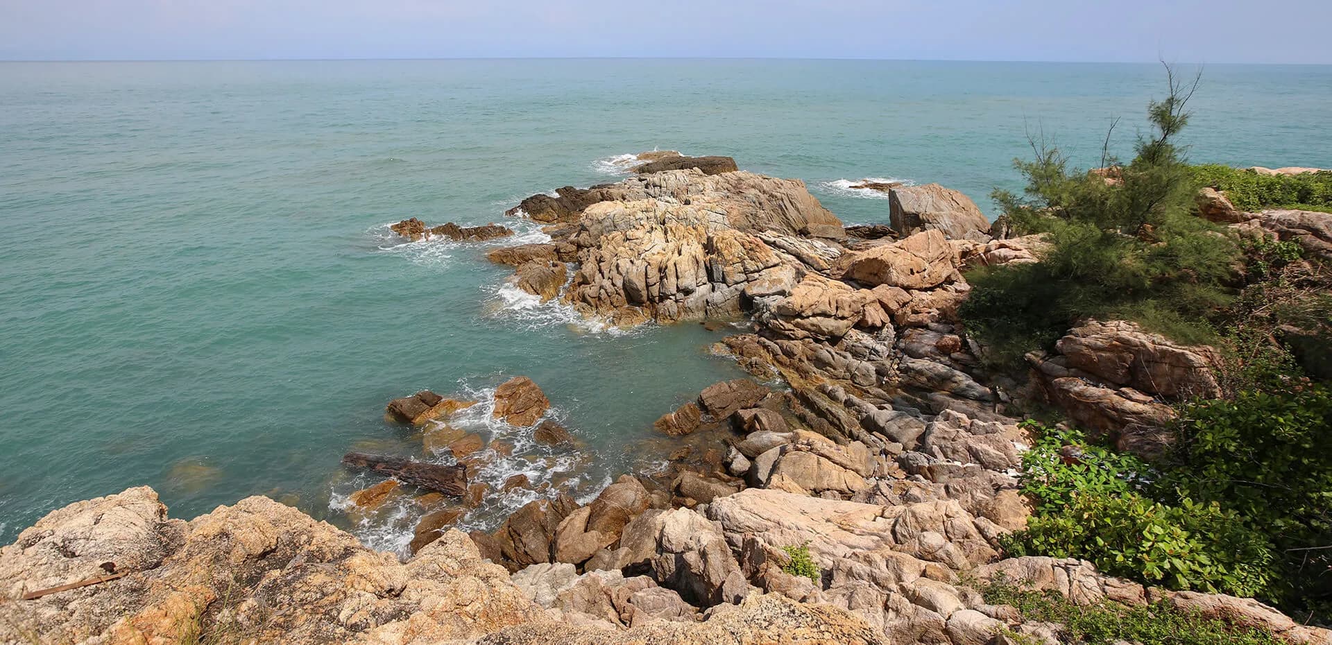 Cape Fahn private island rocky headland and Gulf-of-Thailand coastline off Choeng Mon Beach, Koh Samui