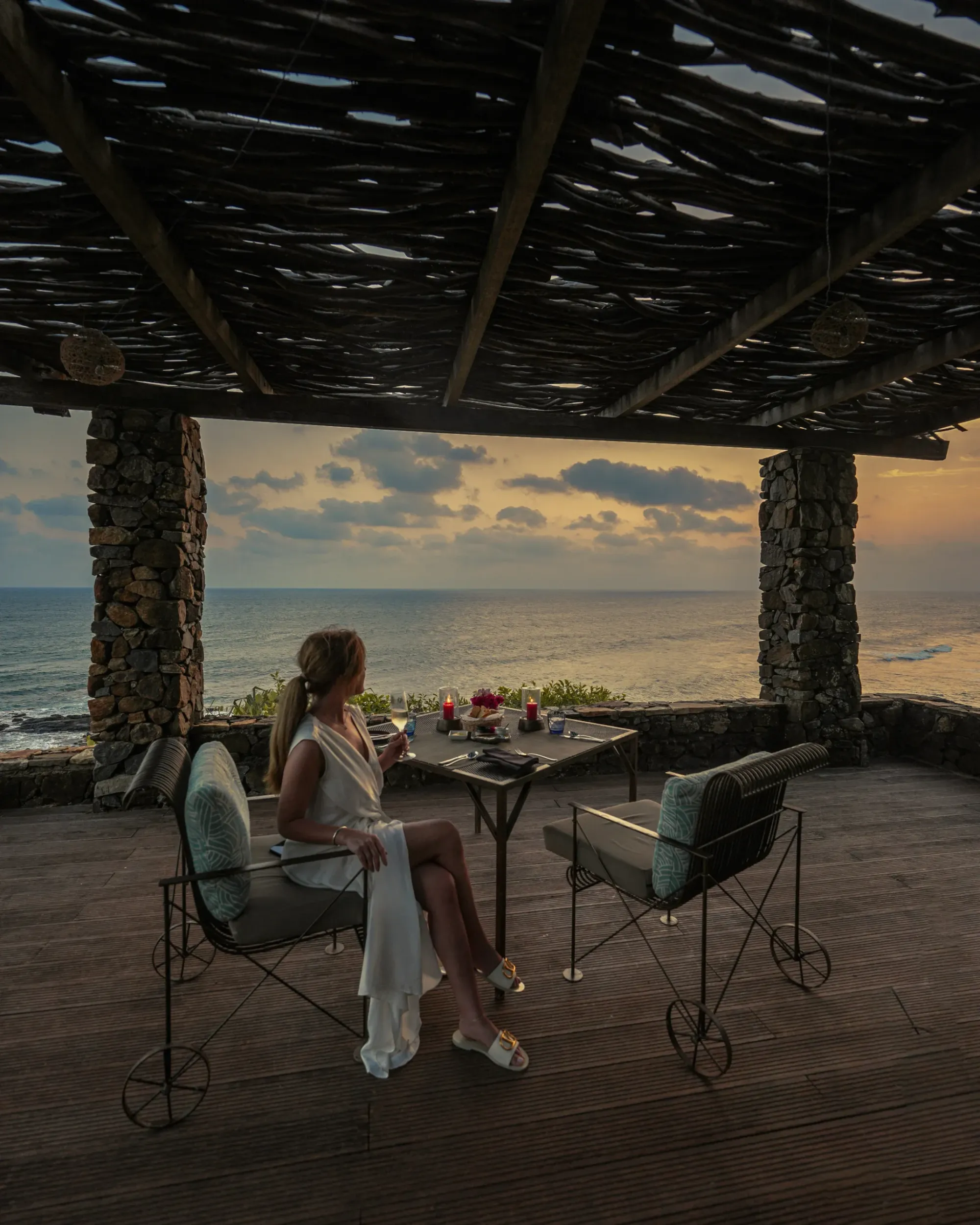 Cape Weligama clifftop headland and crescent Moon Pool glowing above the Indian Ocean at dusk, Sri Lanka