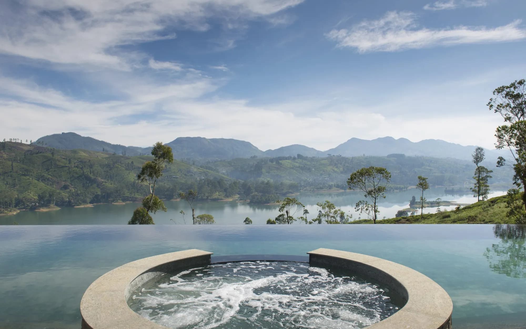 Swimming pool at a Ceylon Tea Trails bungalow framed by Sri Lanka hill-country tea estates