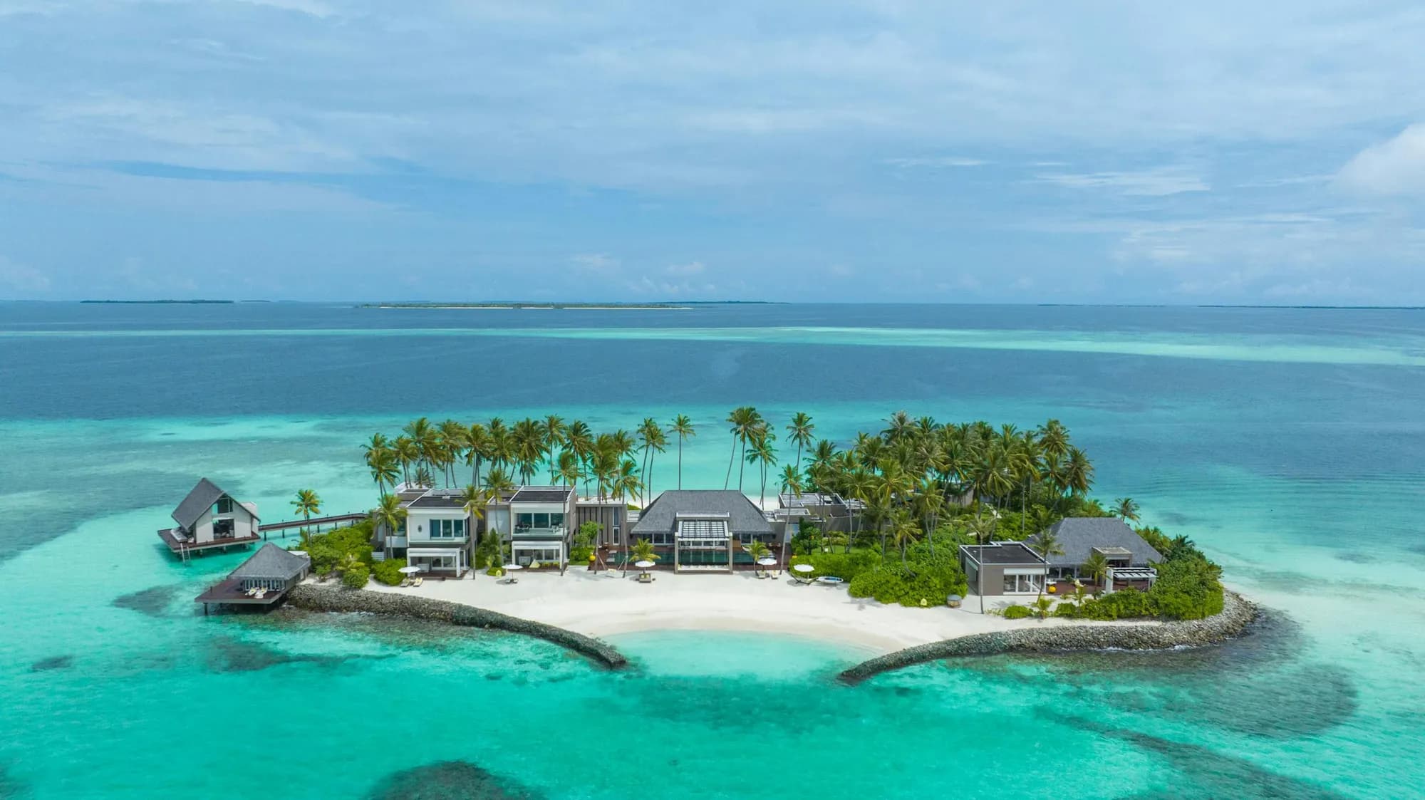 Aerial of Cheval Blanc Randheli private lagoon with over-water villas and turquoise water in Noonu Atoll, Maldives