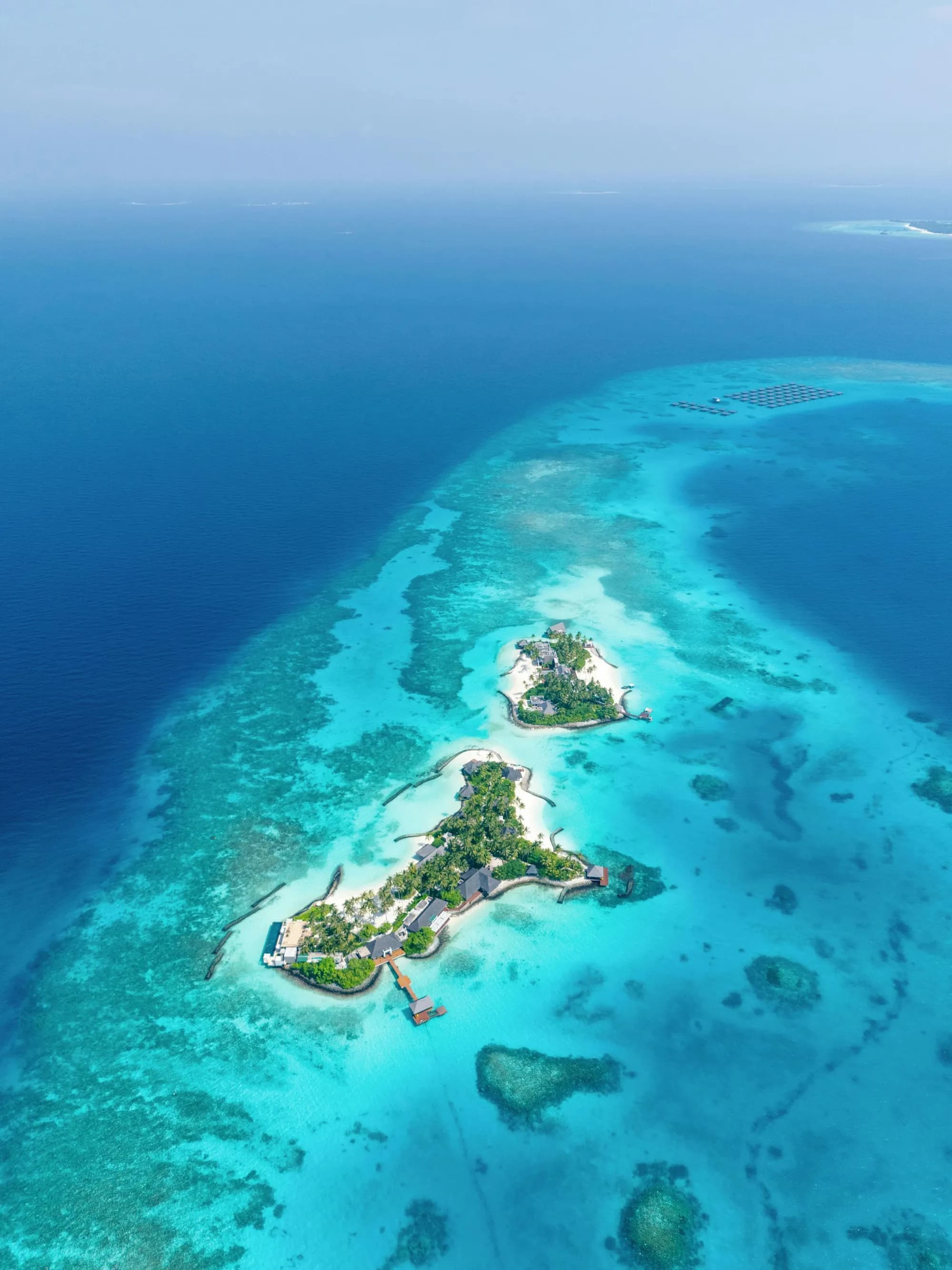 Aerial of Cheval Blanc Randheli five islands and over-water villas in a private lagoon, Maldives