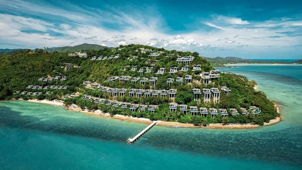 Conrad Koh Samui clifftop pool villas terraced down a hillside above the Gulf of Thailand at golden-hour sunset, Taling Ngam, Koh Samui, Thailand