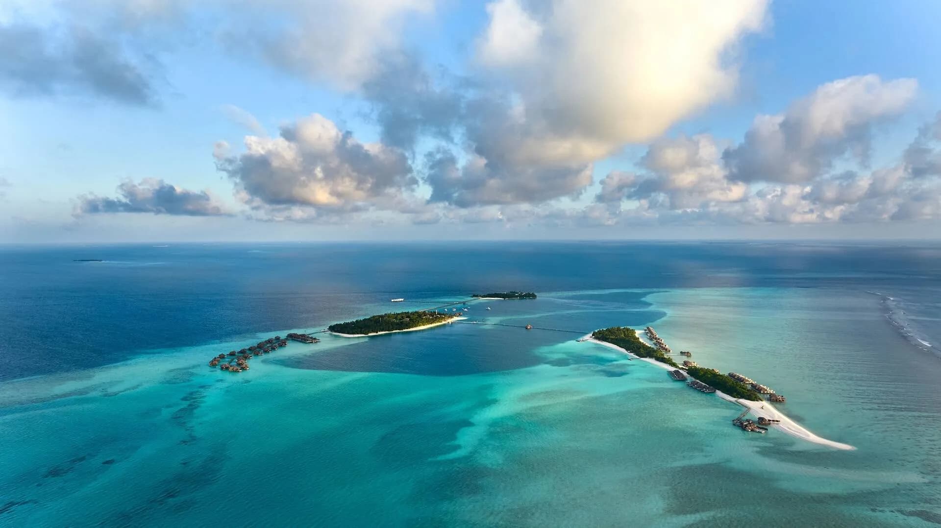 Aerial view of Conrad Maldives Rangali Island twin islands and over-water villas in the turquoise South Ari Atoll lagoon