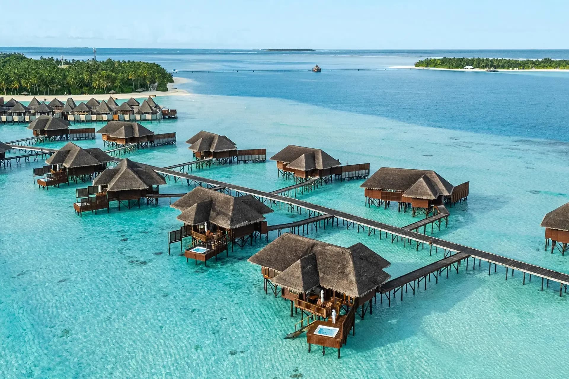 Seaplane and resort jetty arrival over the turquoise lagoon at Conrad Maldives Rangali Island