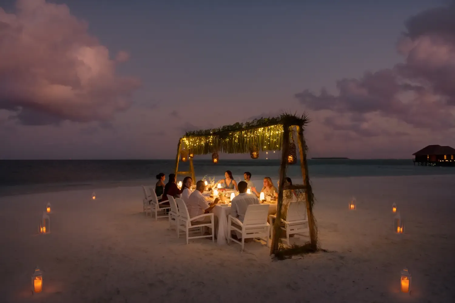 Private beach destination dinner set up under the stars at Conrad Maldives Rangali Island