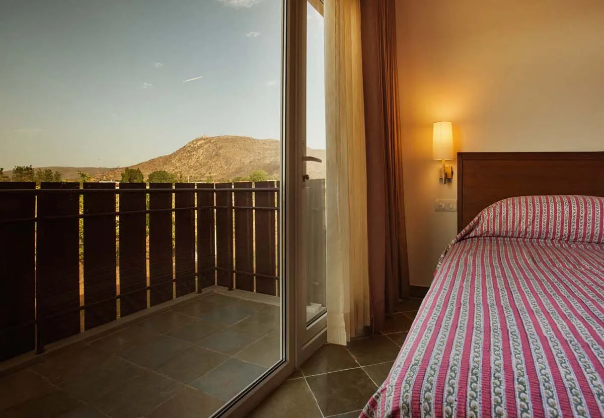 Indo-Saracenic facade of Dera Masuda luxury resort Pushkar below the Savitri Temple hill