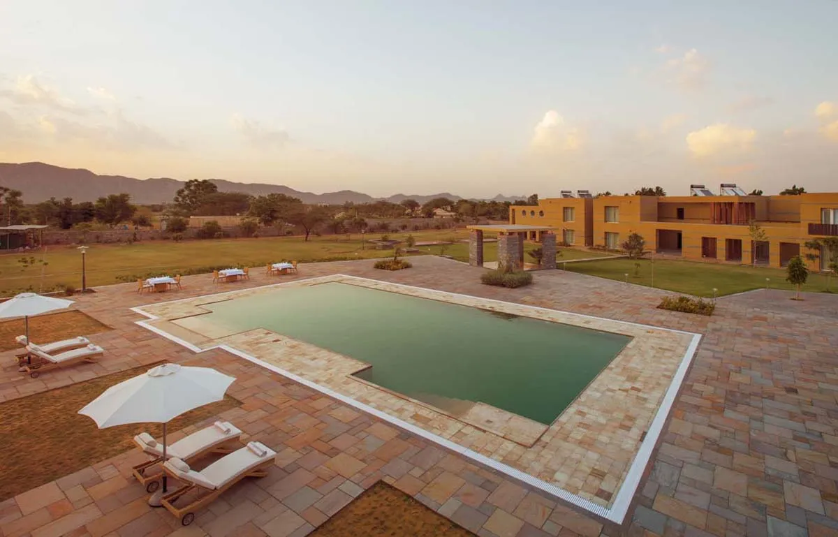 Large 15000 sq ft pool deck with shimmering-lake effect at Dera Masuda resort Pushkar