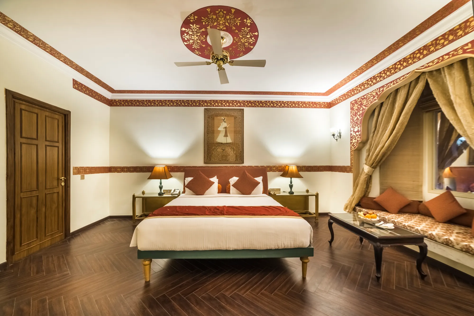 Heritage-style sandstone suite with king bed at Fort Rajwada Jaisalmer