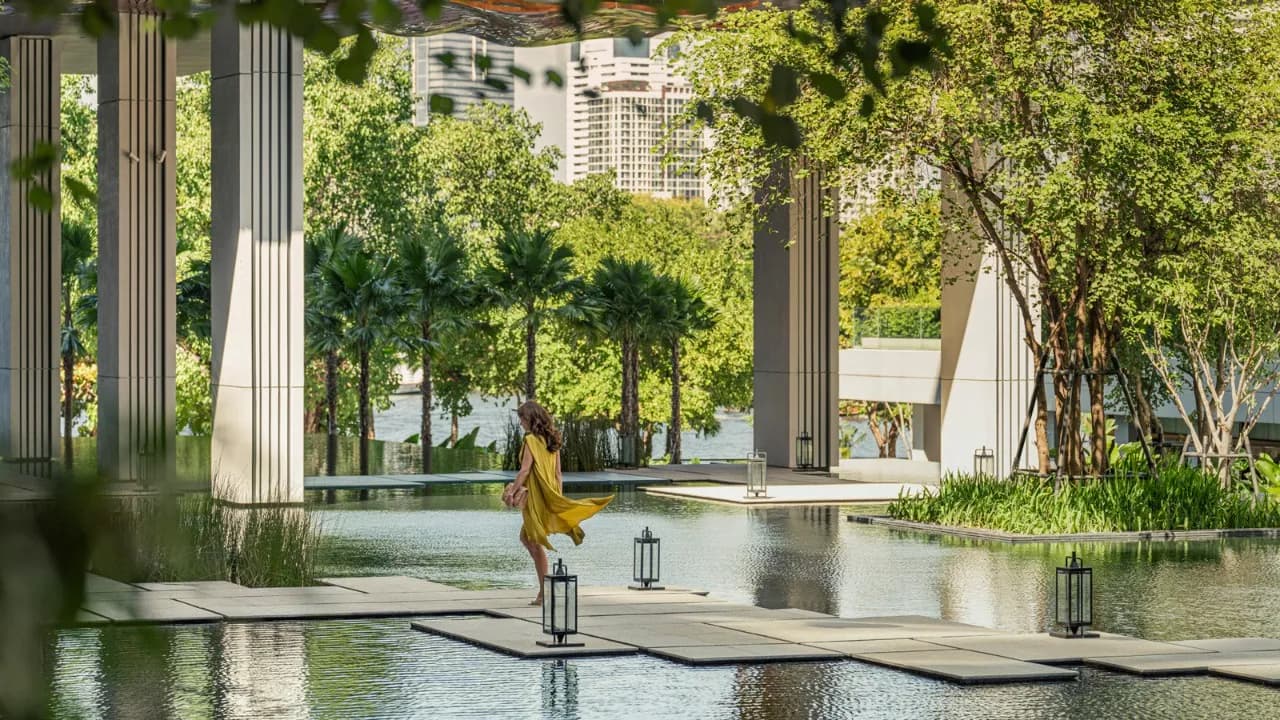 Landscaped lily-pond water courtyard with columns and greenery at Four Seasons Hotel Bangkok at Chao Phraya River