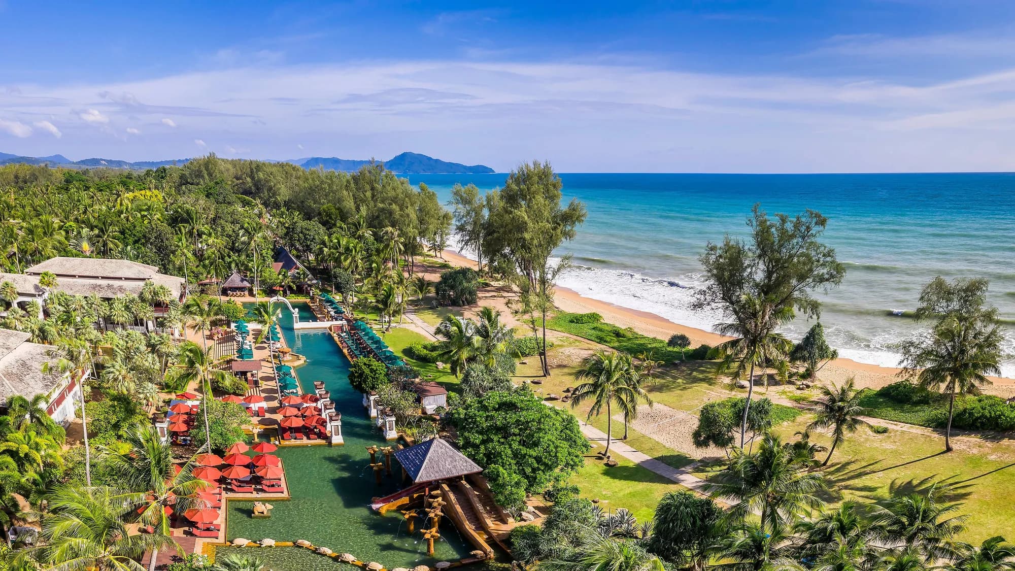 Aerial exterior of JW Marriott Phuket Resort & Spa lagoon pools and beachfront on Mai Khao Beach, Thailand