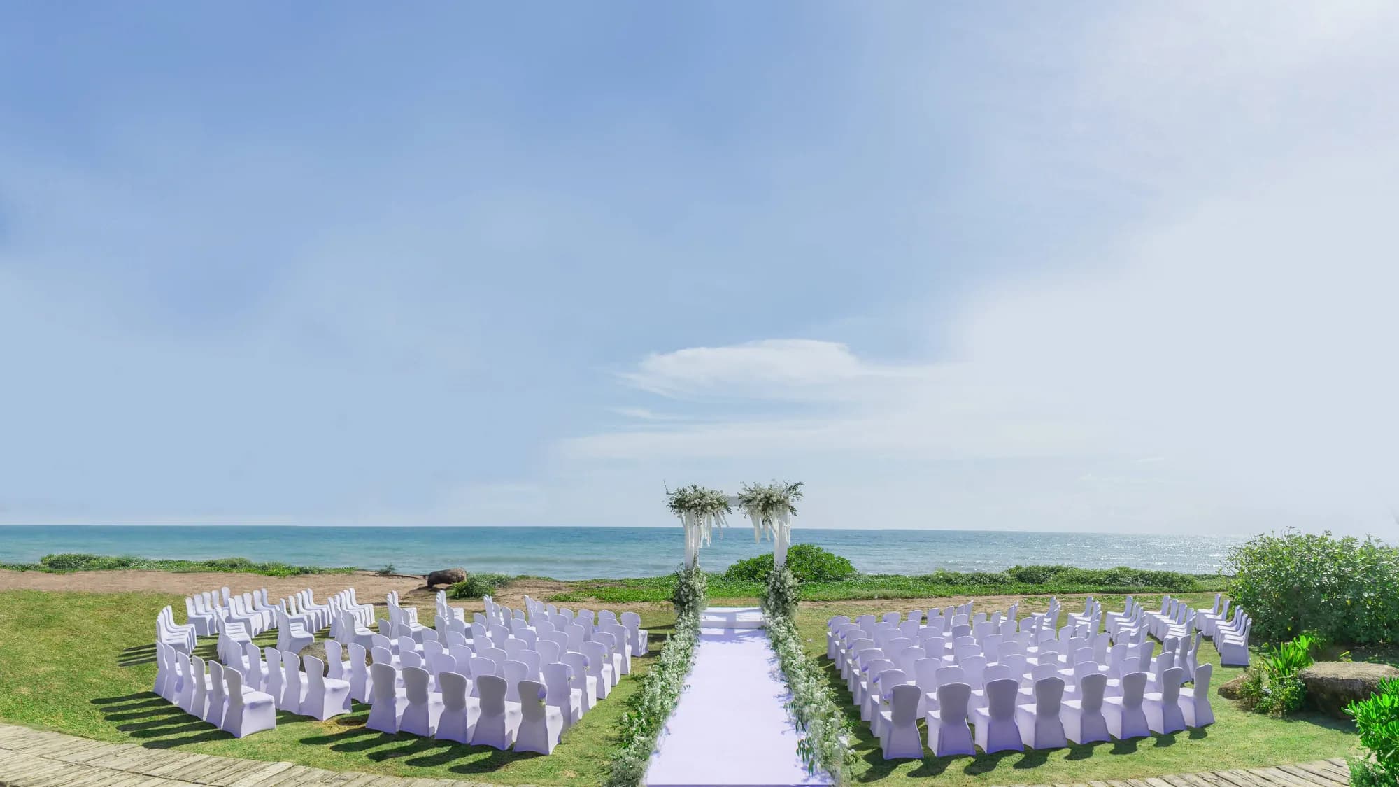 Beachfront wedding ceremony aisle and setup on the sand at JW Marriott Phuket Resort & Spa, Mai Khao
