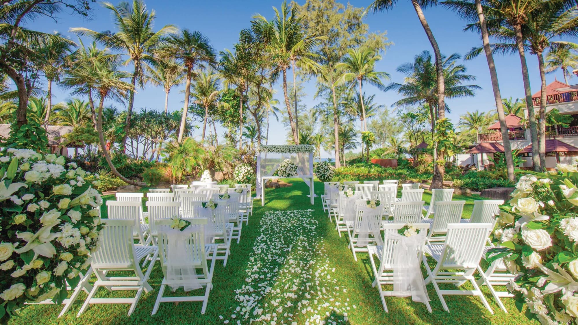 Beachfront wedding ceremony arch and seating by the Andaman Sea at JW Marriott Phuket Resort & Spa
