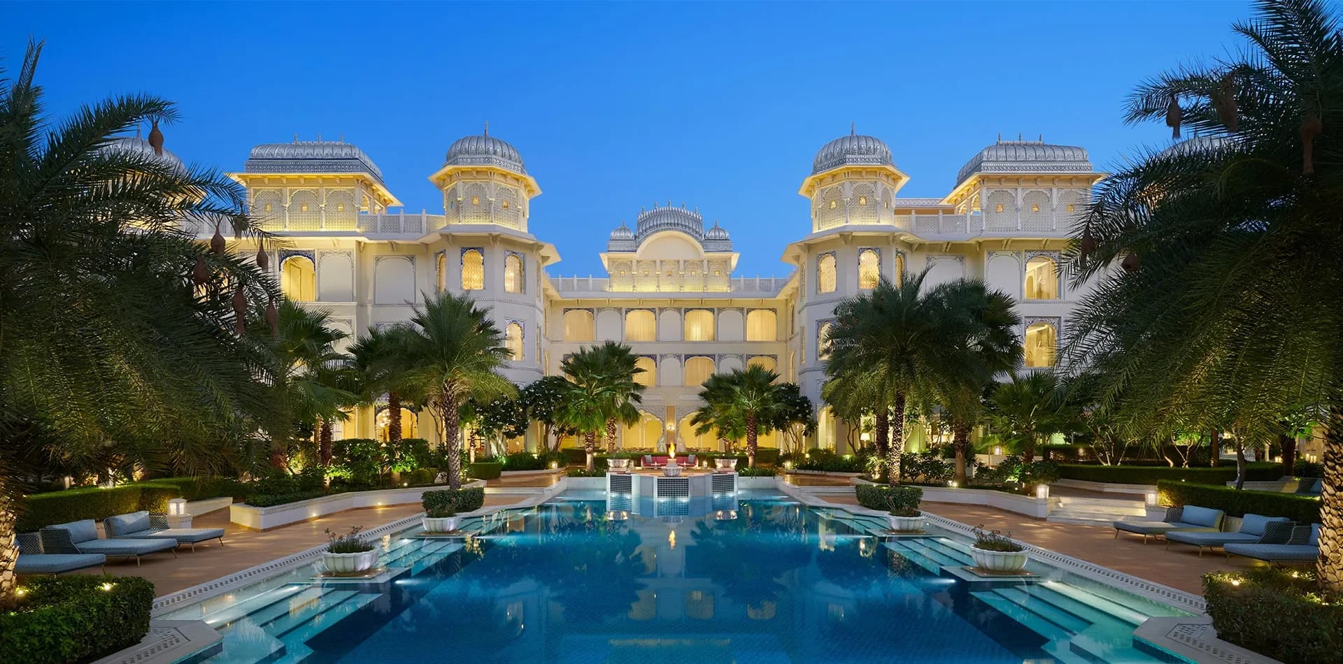 The Leela Palace Jaipur palace-resort exterior with Rajput-Mughal architecture near Amer Fort